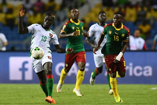 Guinea-Bissau's forward Piqueti advances with the ball past Cameroon's defender Collins Fai before scoring a goal during the 2017 Africa Cup of Nations group A football match between Cameroon and Guinea-Bissau at the Stade de l'Amitie Sino-Gabonaise in Libreville on January 18, 2017. / AFP / GABRIEL BOUYS (Jan. 17, 2017 - Source: AFP)