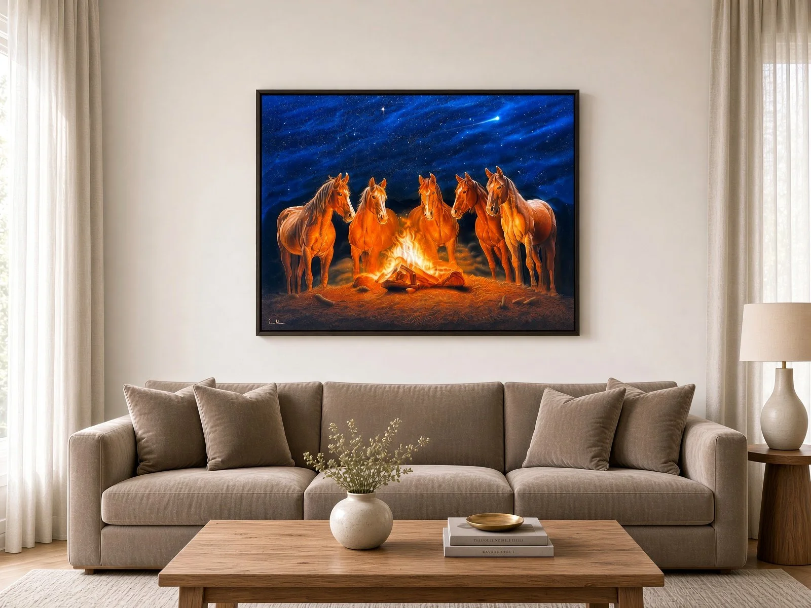 Living room with a beige couch, beige curtains, a white side table, and a framed painting of five horses around a campfire under a starry night sky.