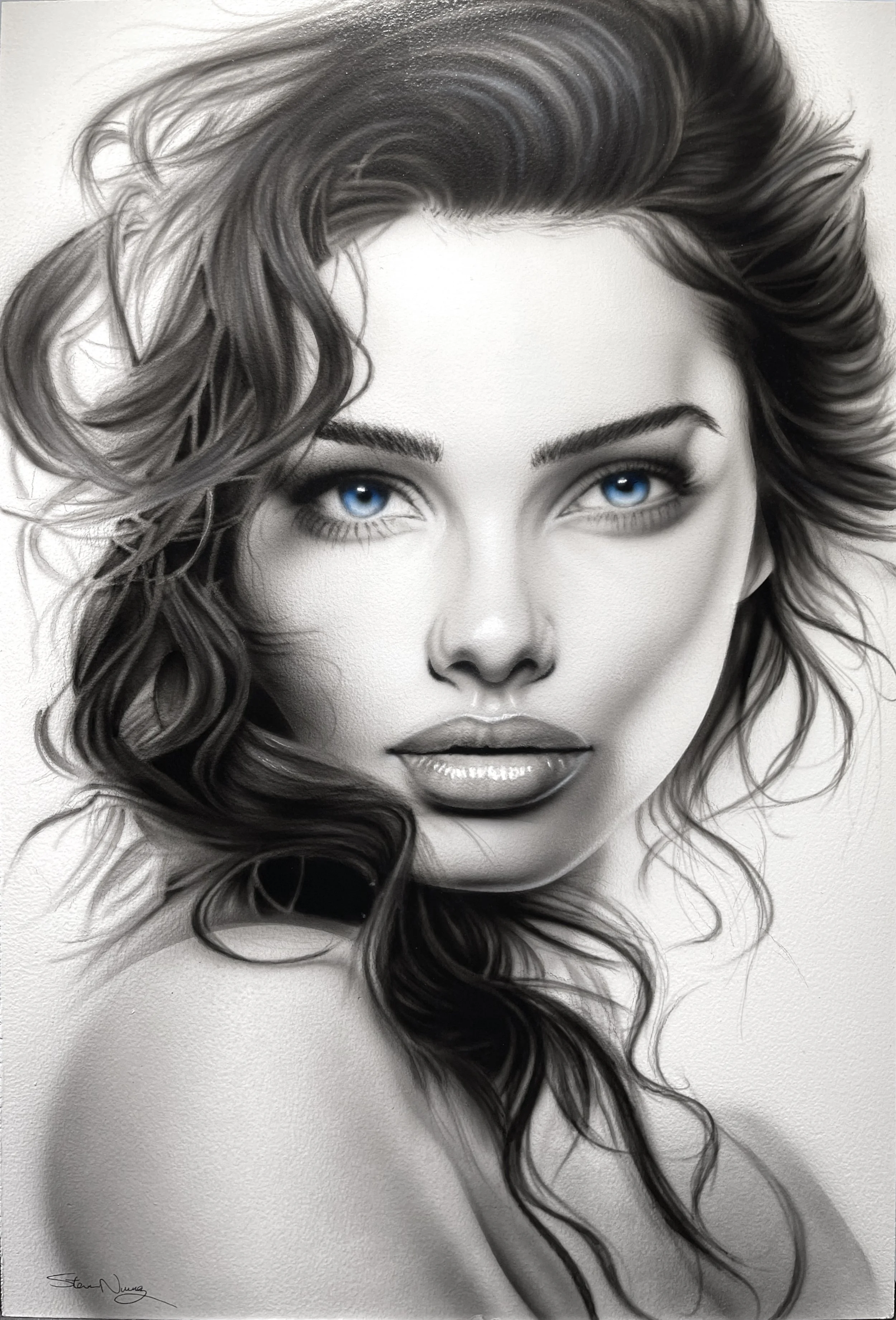 Black and white portrait of a woman with wavy hair and bright blue eyes.