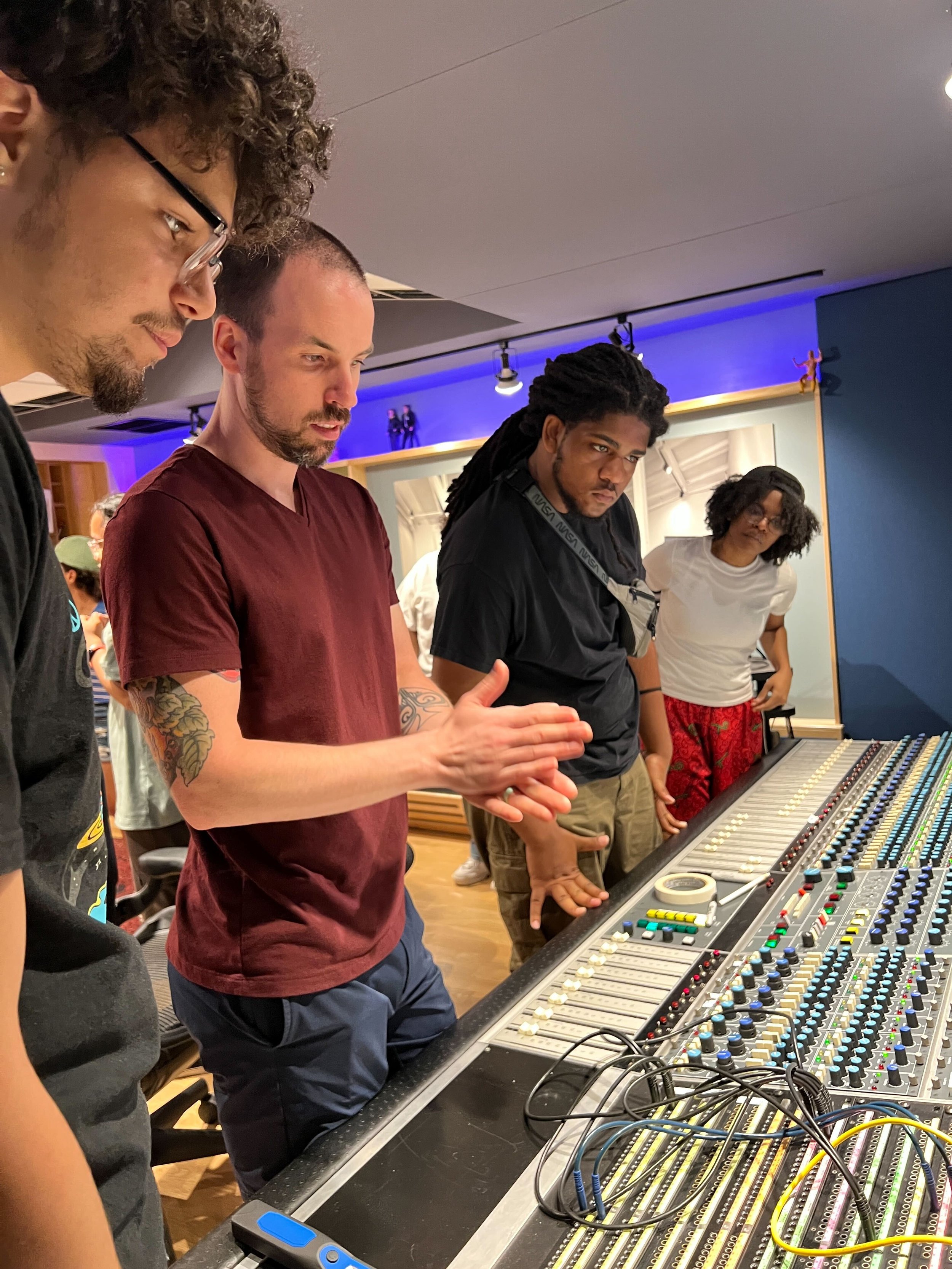   Apprentices Nino Leite, Kuran Freeman, and Noel O’Neil learn about the mixer/soundboard  