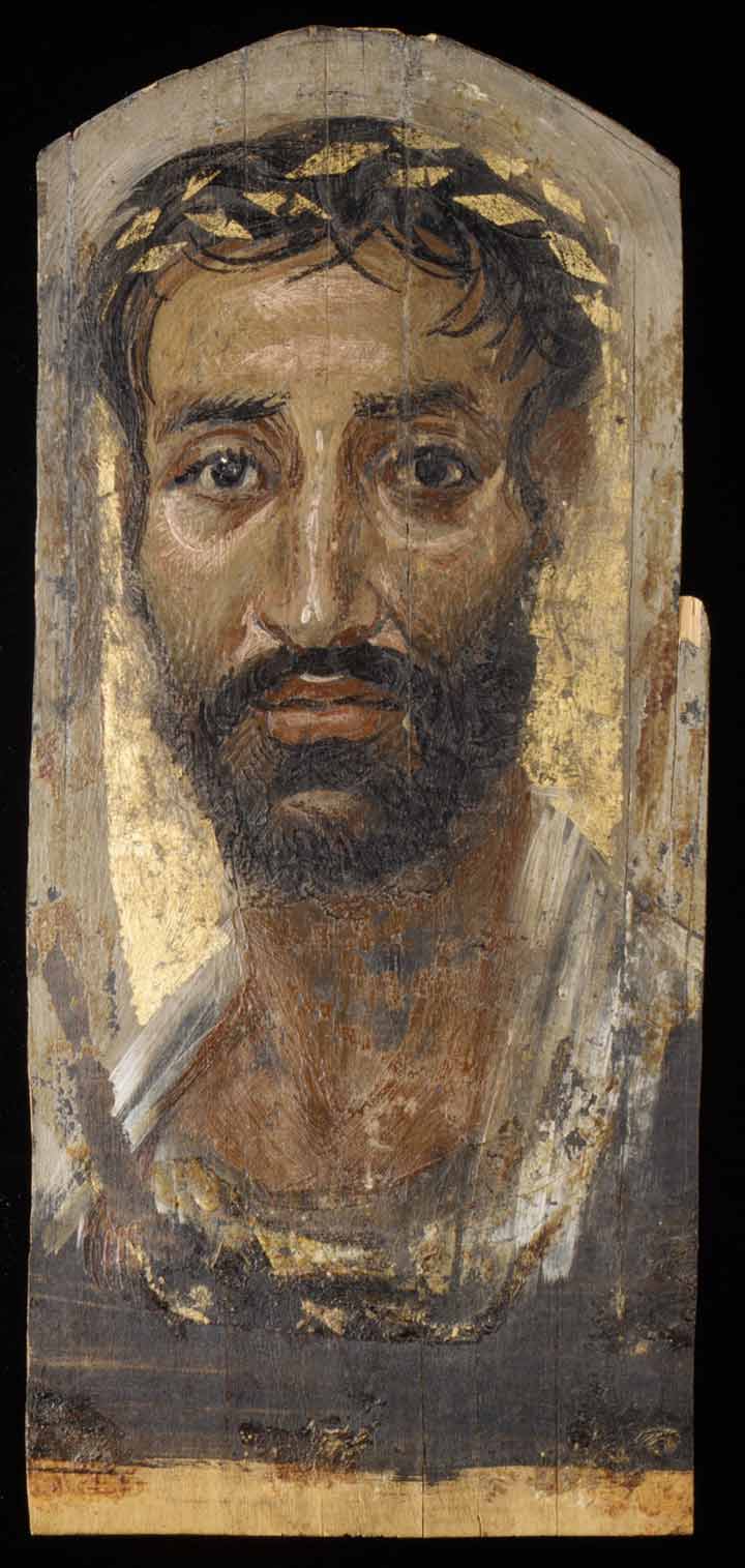 Above: Portrait of a thin-faced man, 2nd century A.D. Egypt, Roman. Encaustic, limewood, gold leaf, H. 16 5/8 x W. 7 3/8 in. (42.3 x 18.7 cm). The Metropolitan Museum of Art, New York, Rogers Fund, 1909 (09.181.3)