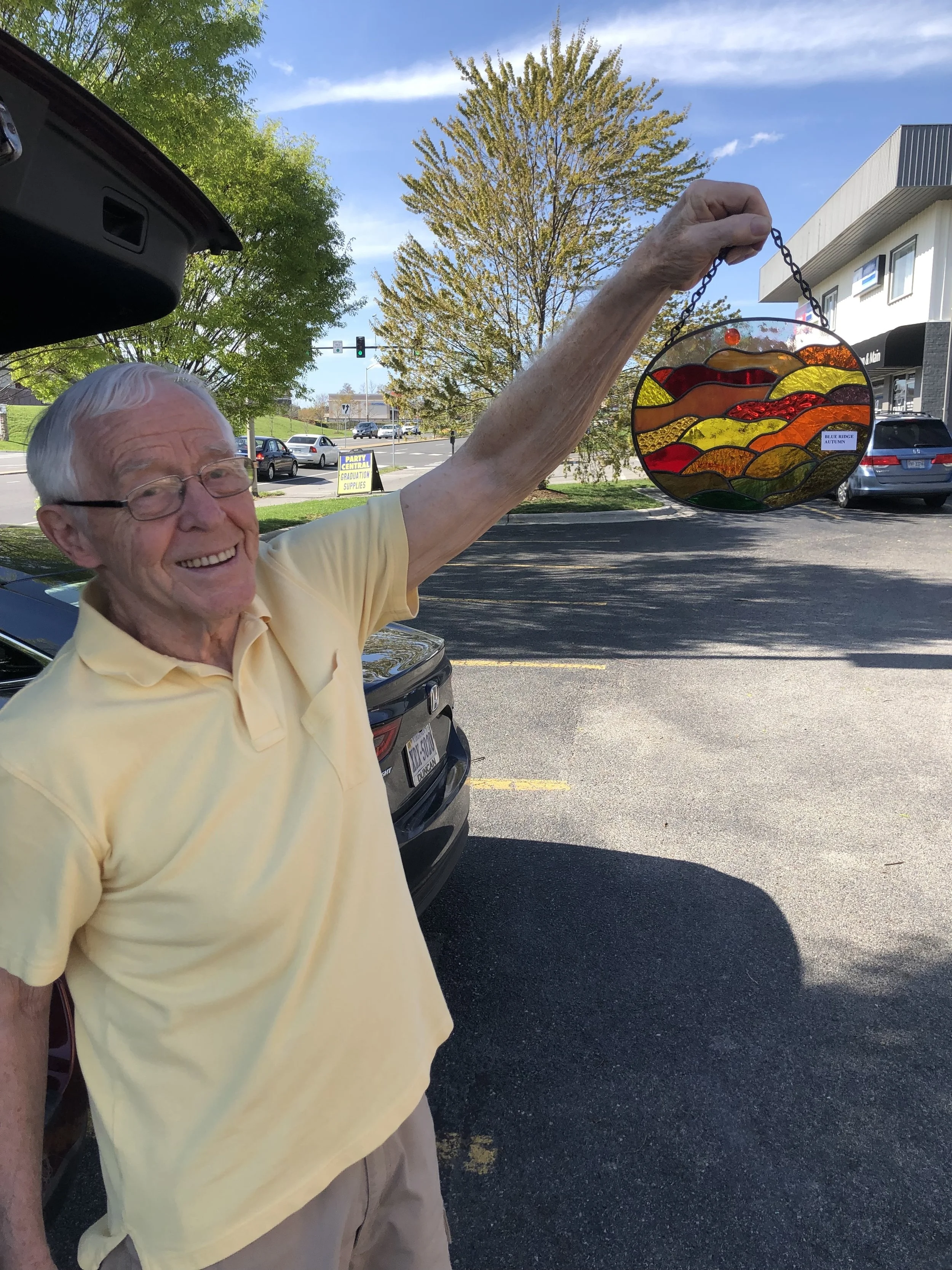 Local artist, Mike Bircher, proudly displaying the 2019 50K male/female champion prize.