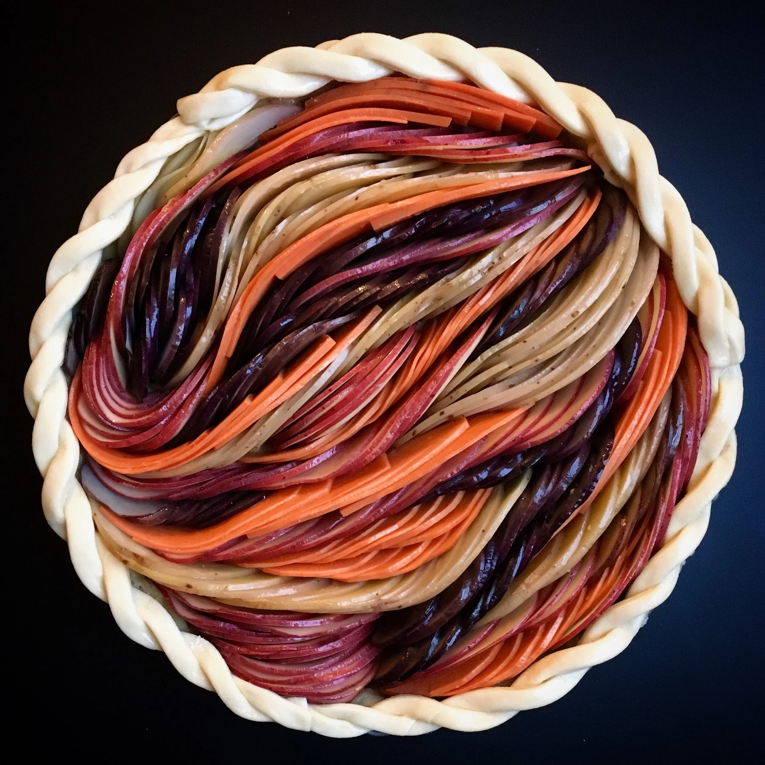  Date: December 4th, 2017   Friend or foetato? 🥔| Spud redux of my pear tart with red, purple, New, and sweet potatoes (all hand-sliced because I’m a masochist and I still can’t decide on a mandolin) and melty Raclette. Carbz and cheese: the lifespu