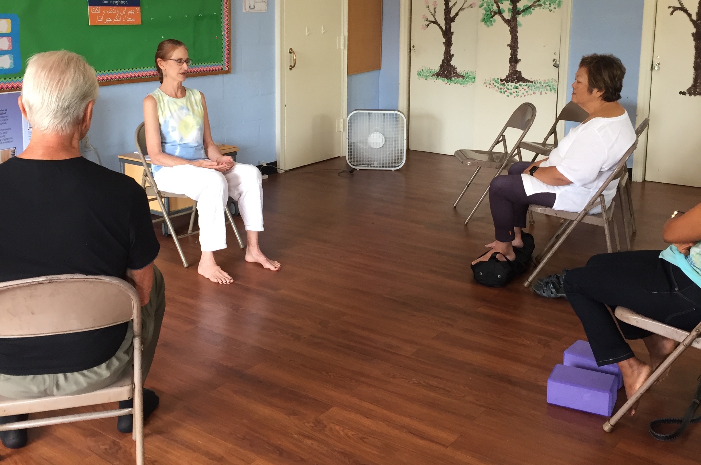 Michèle guiding participants at ASAP Washington, DC, a nonprofit organization; volunteer support. Learn more about ASAP at www.asylumprojectdc.org . Photo used courtesy of MiRé Yoga.