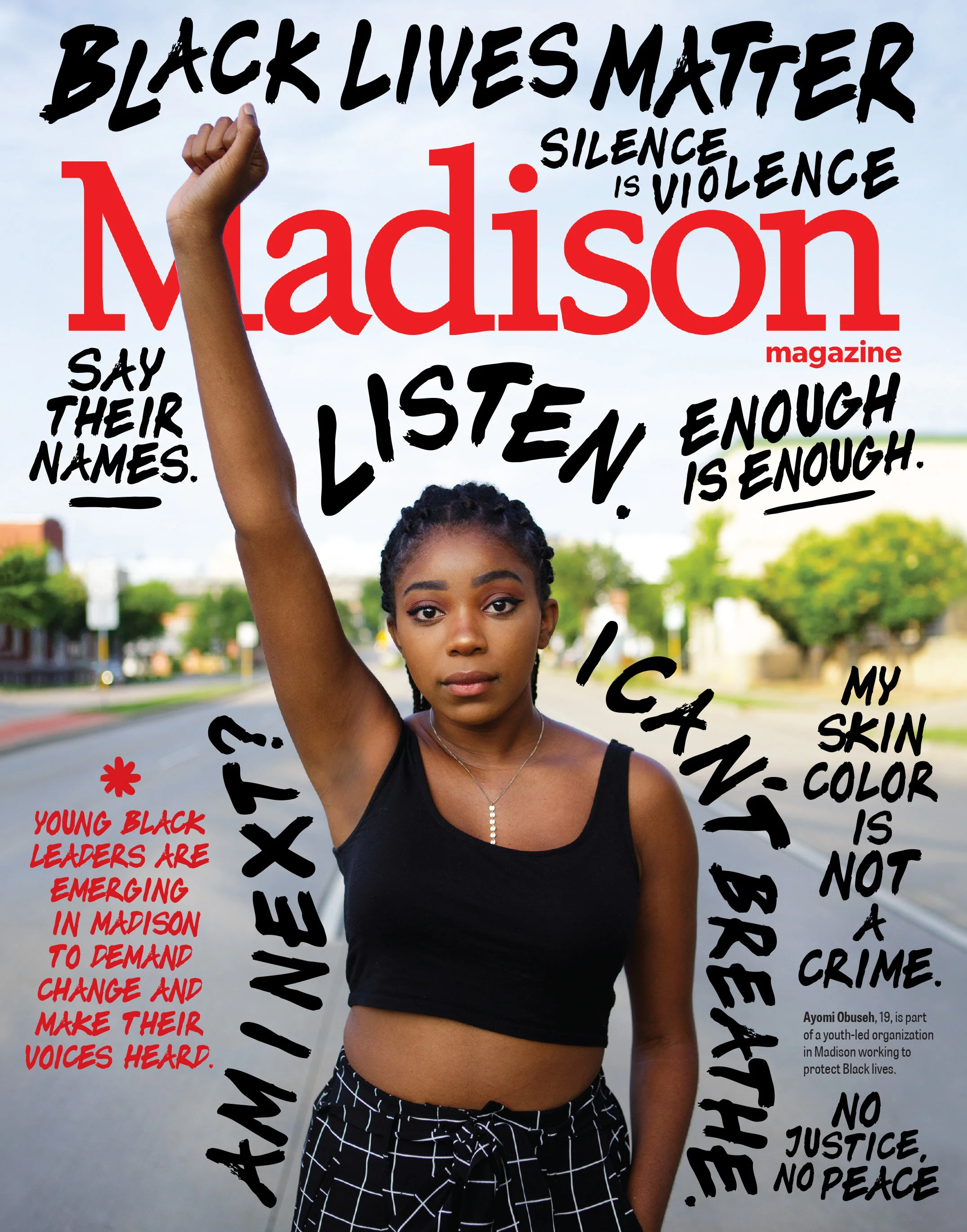 Organizer for Black youth-led activist group Impact Demand and University of Wisconsin-Madison student Ayomi Obuseh raises a Black Power fist on Madison’s East Washington Avenue. The state capitol building can be seen behind her.