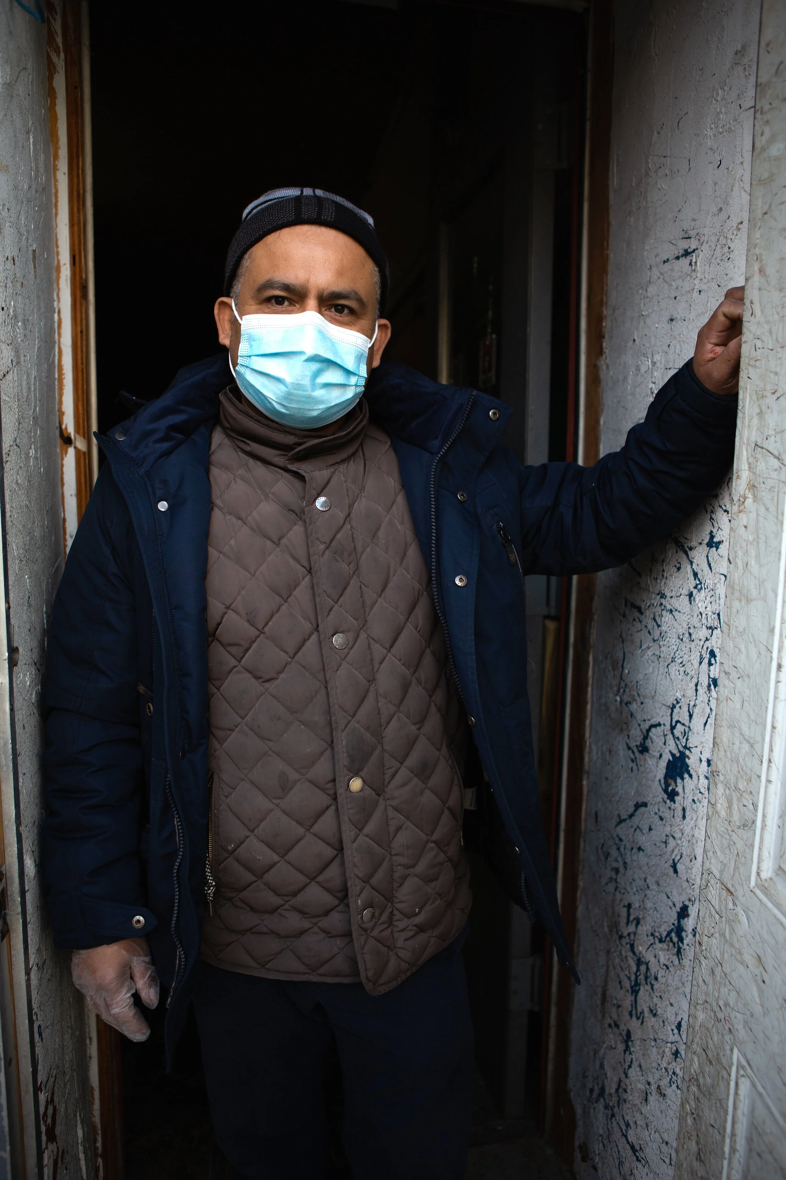 Esteban Estevez stands outside the entrance to his furniture upholstery workshop which he donated for the day as a community testing site. Providing testing and vaccines out of trusted community establishments like Estaban’s helps the NYC Department…