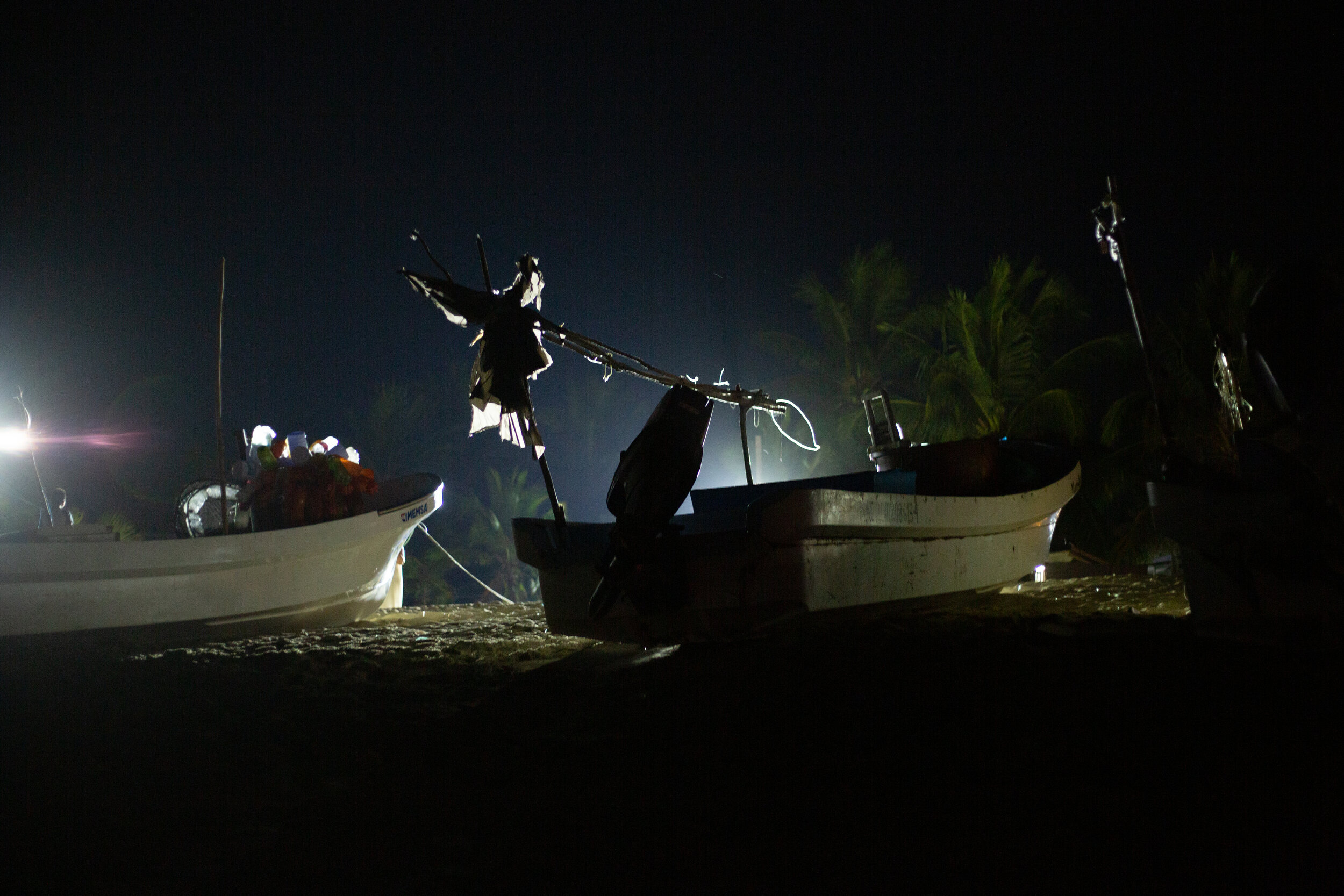 Floodlights illuminate boats left onshore overnight. Fishermen leave at various hours of the evening through the early morning depending on what type of fish they’re pursuing.
