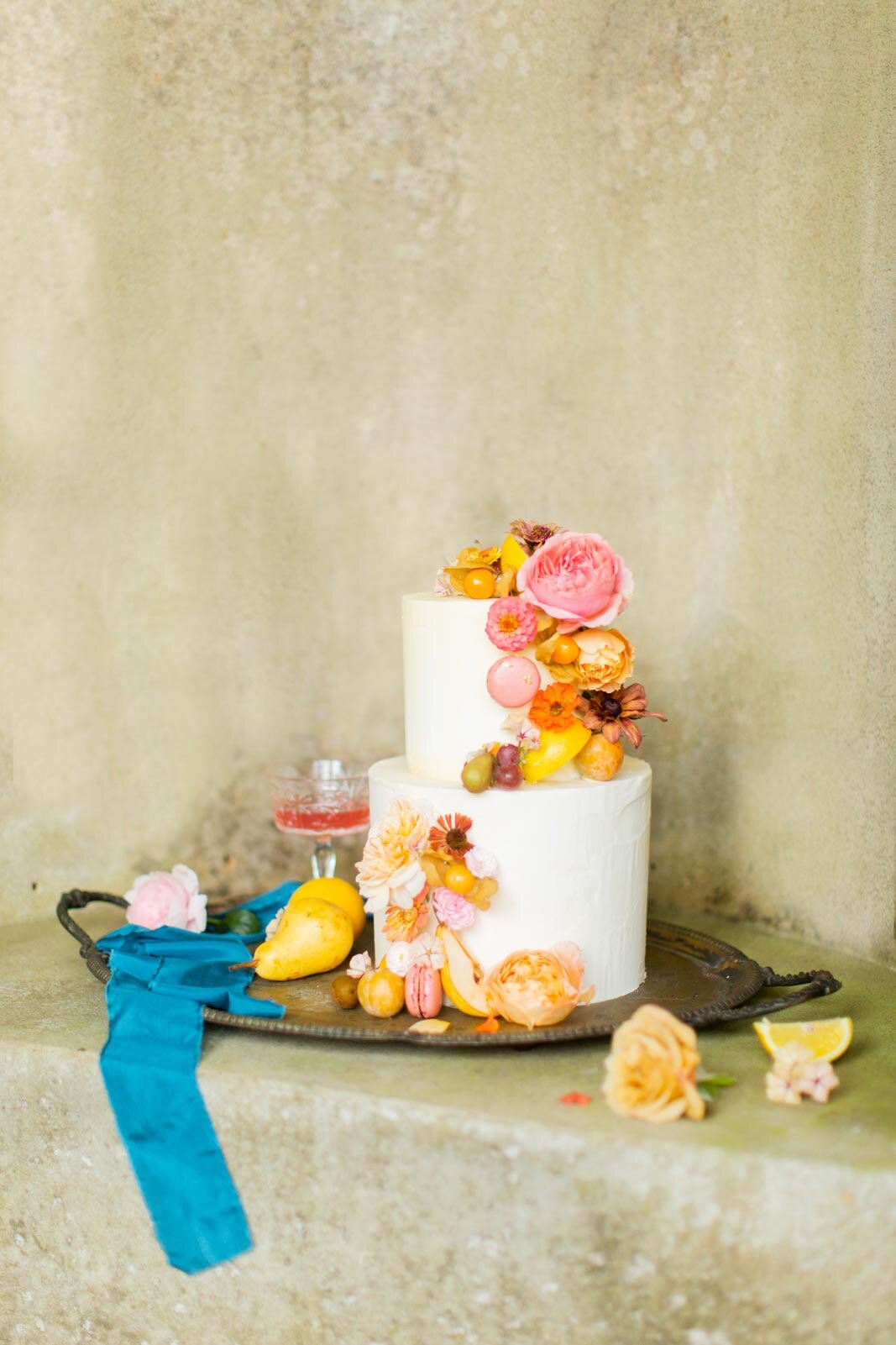 romantic-buttercream-cake-with-cascading-floral-and-fruit-decorations.jpg