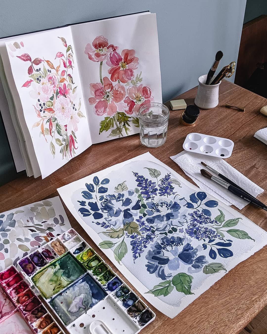 A desk filled with blue gouache florals 🌿