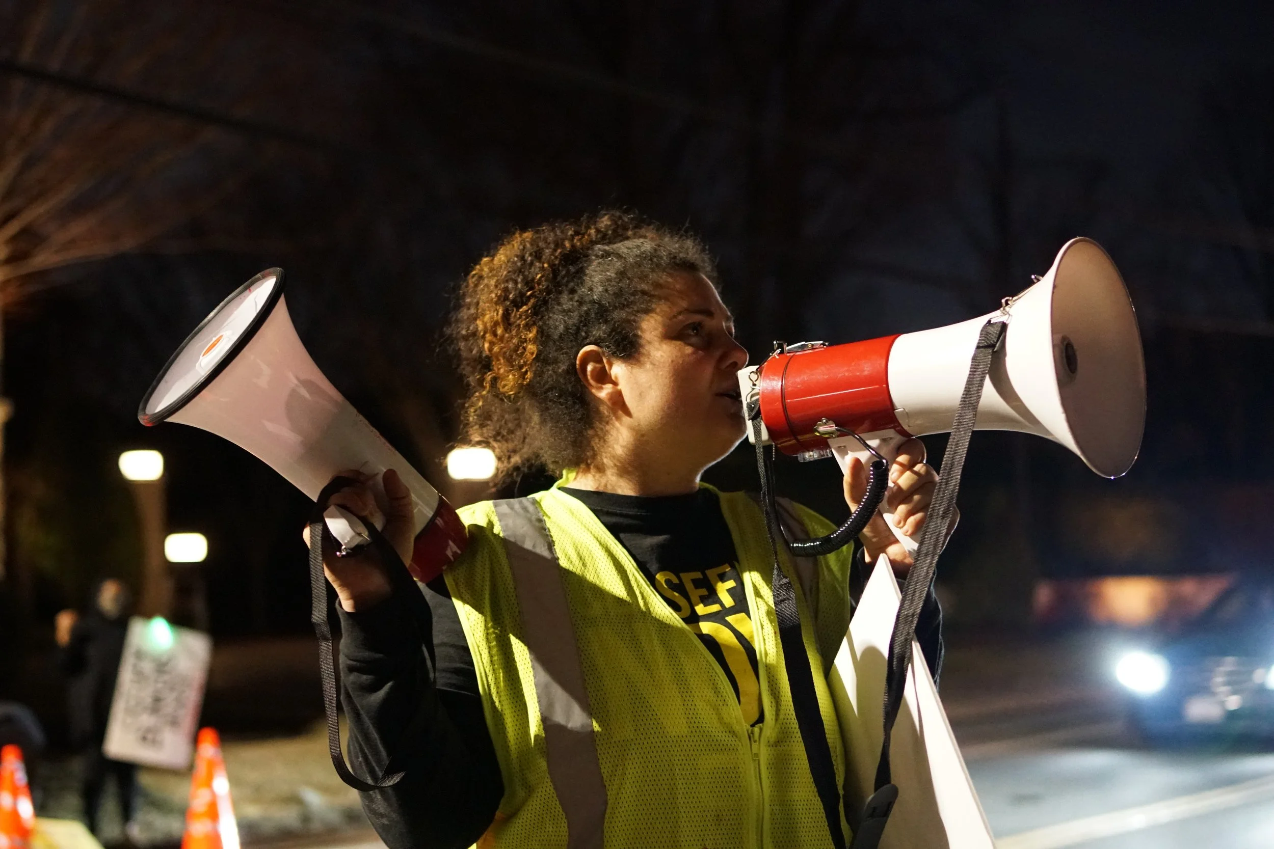  Lead organizer and activist Hazami Barmada announces in a megaphone on night one the protest demands.  