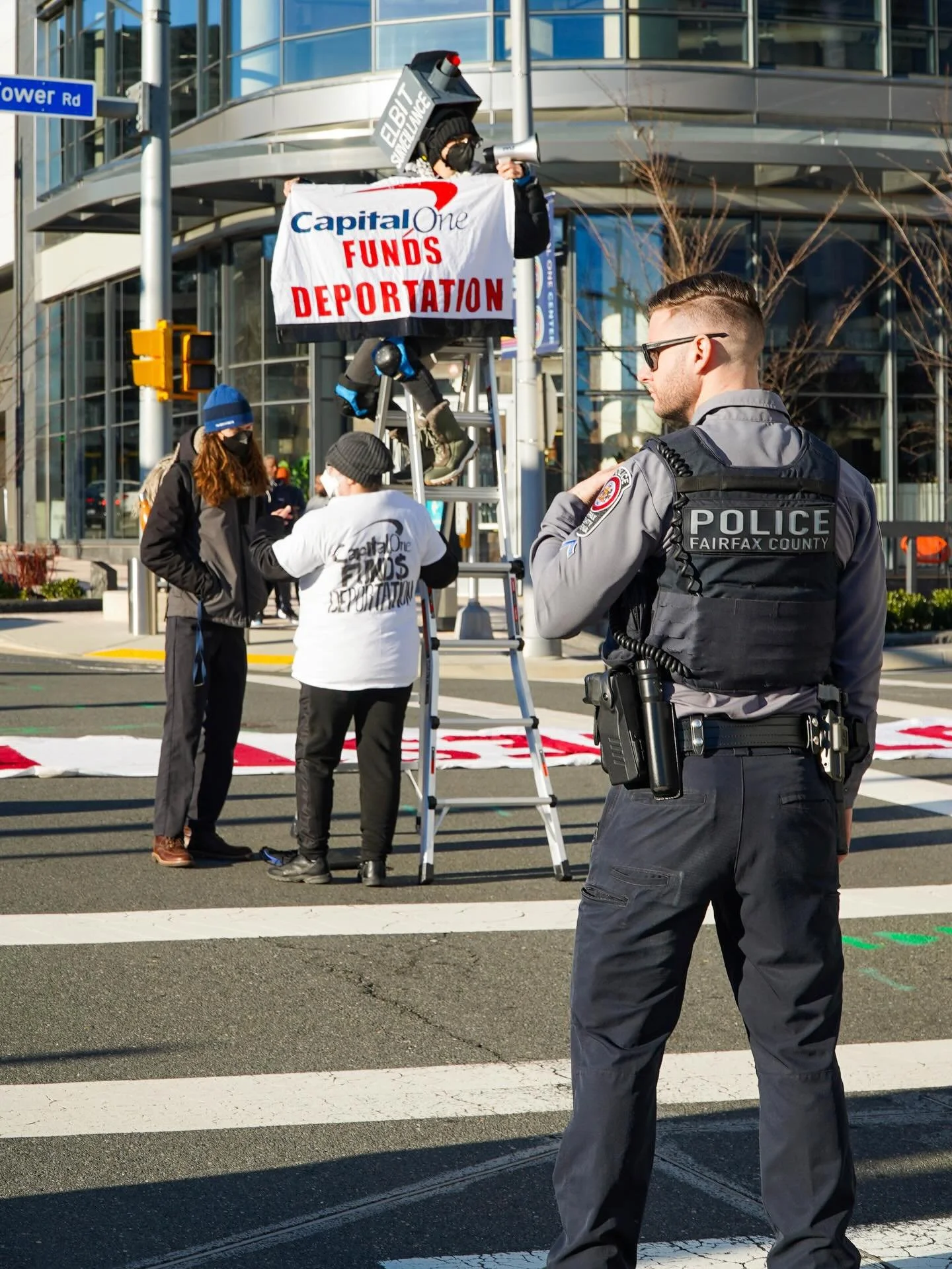 McClean, Virginia &ndash; January 13, 2026. 

Activists successfully disrupted Capital One executive&rsquo;s workday by blocking the main entrance/intersection of the Capital One headquarters at eight in the morning as employees were scheduled to arr