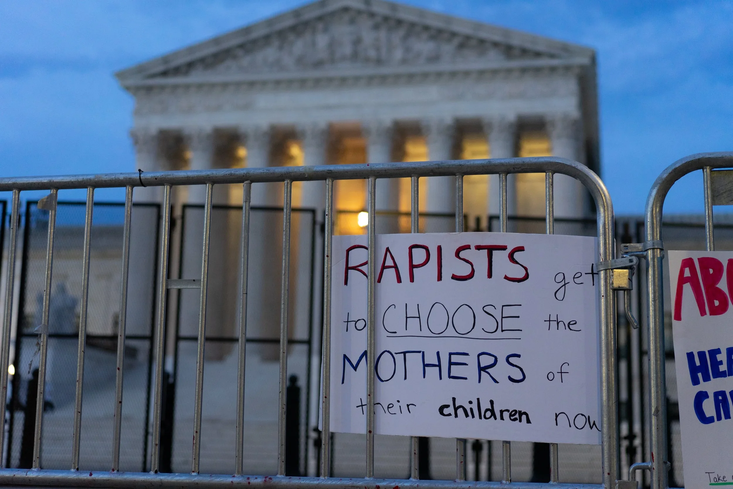 A sign hangs on the barrier outside the U.S. Supreme Court after Roe V. Wade was overturned in June 2022