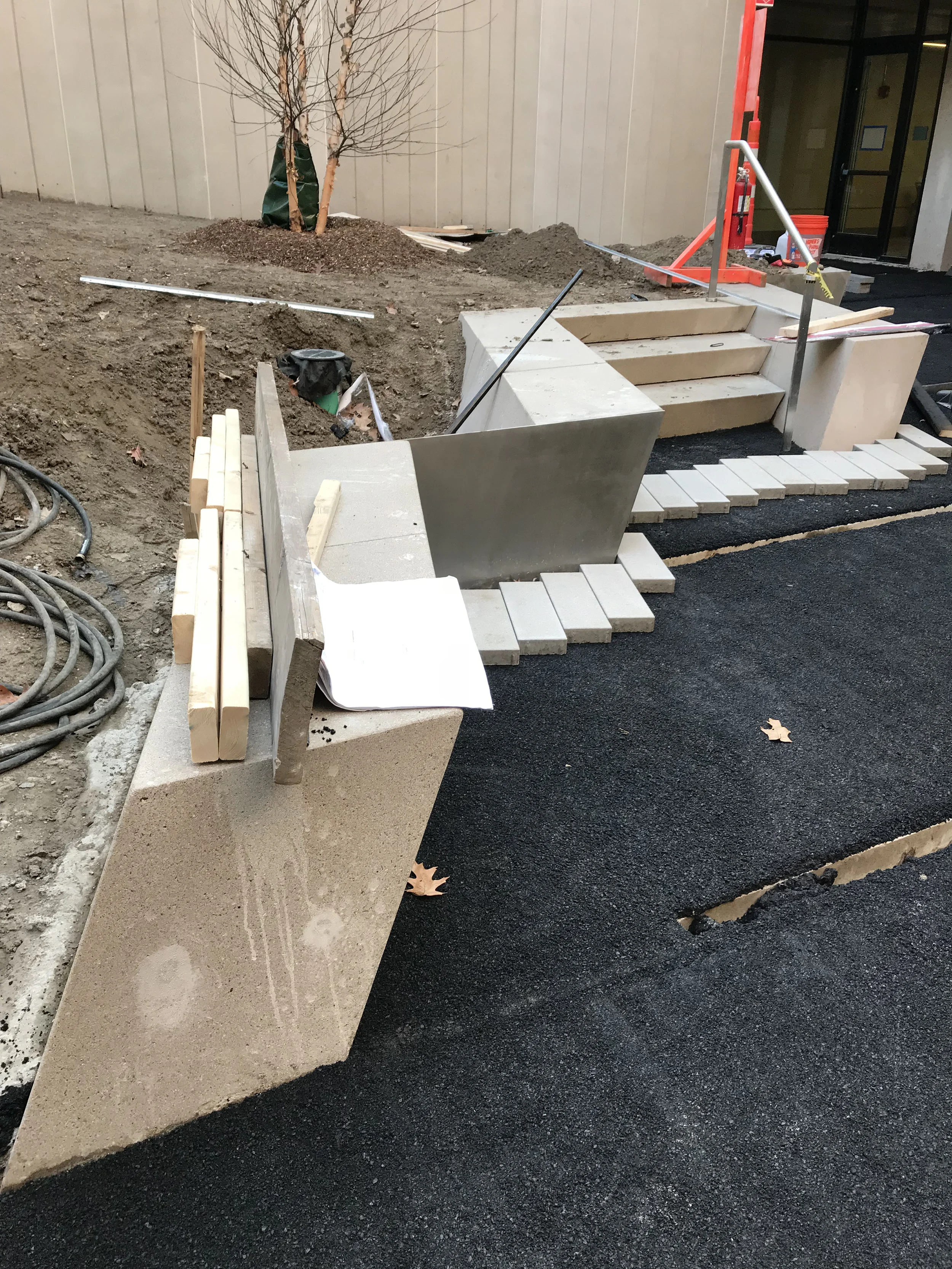 construction progress of precast benches, stairs, and steel plates