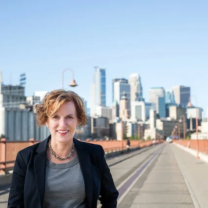 Betsy Hodges was the 47th mayor of Minneapolis. In her role as mayor, she focused on three clear goals: running the city well, growing a great city and increasing equity. Her priorities were ensuring the City works well for everyone and that all people can contribute to – and benefit from – the growth and prosperity of Minneapolis. Some of Mayor Hodges' key initiatives included: her Cradle to K Cabinet, creating a Zero Waste Minneapolis, improving police-community relations, and helping small businesses thrive. Prior to becoming mayor, Betsy Hodges served on the Minneapolis City Council for eight years as the council member from Ward 13. On the Council, she served as chair of the Ways and Means/Budget Committee and the Intergovernmental Relations Committee. One of her major accomplishments was leading the fight to reform a broken closed-pension system that served neither the pensioners nor taxpayers well, which helped avert a $20-million increase in the property tax levy in 2012. In her spare time, Mayor Hodges works on staying physically fit, writes, reads poetry and enjoys seasonal viewings of “Die Hard,” her favorite movie. She is known for her extensive collection of Wonder Woman memorabilia. She is an occasional karaoke singer with a very limited vocal range. A Minnesota native, Mayor Hodges is married to Gary Cunningham, CEO and President of the Metropolitan Economic Development Association and a member of the Metropolitan Council. They have two children, four grandchildren and two cats