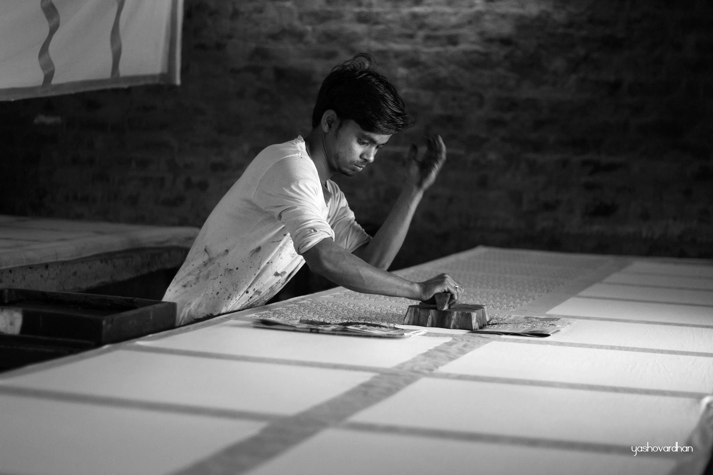ON A BEAUTIFULLY SUNNY DAY, A YOUNG BLOCK PRINTING ARTIST AT WORK