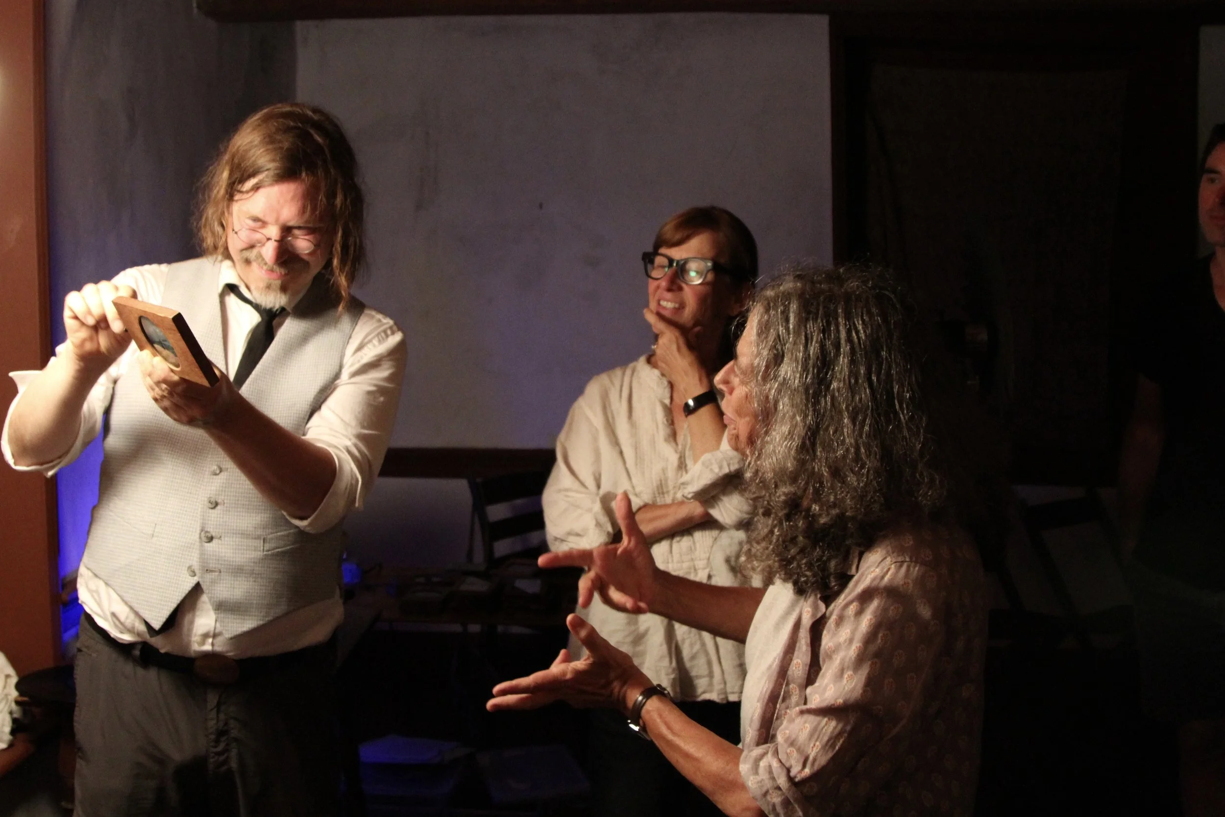 Onlookers view the ‘slip’ magic lantern slide outside of the Victorian projector