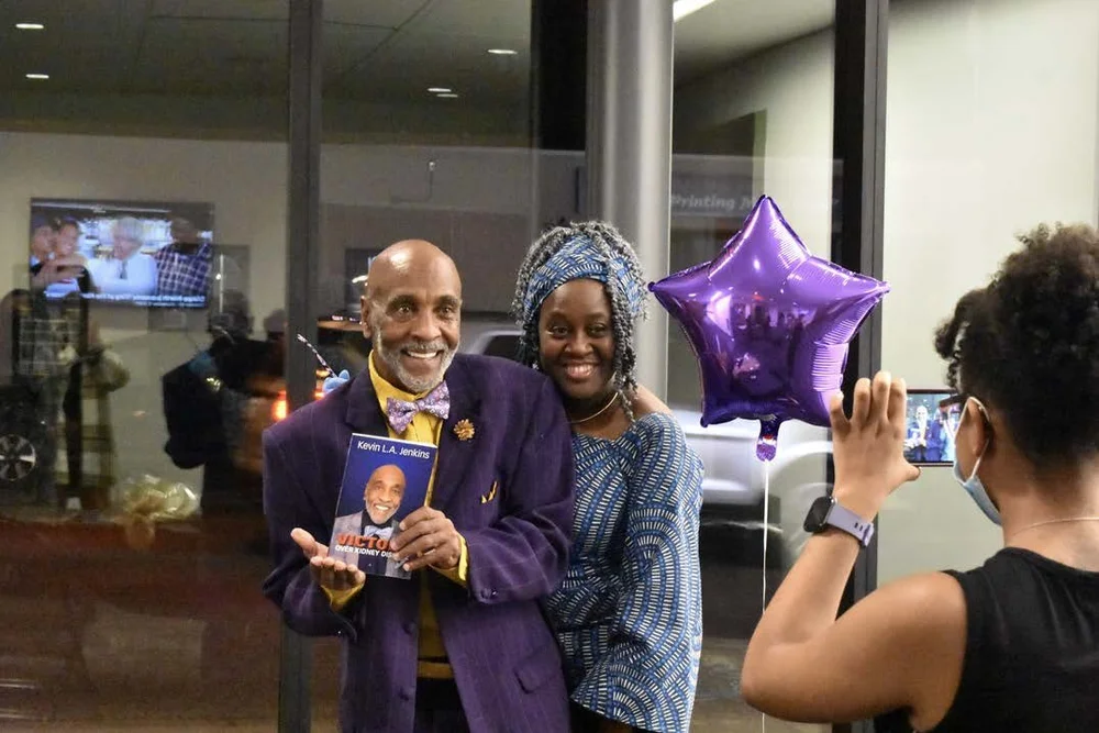 Kevin Jenkins with book and attendee.jpg