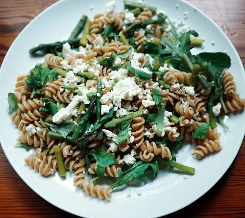Homemade pasta with asparagus, arugula, and feta cheese
