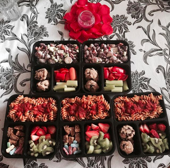Meal prep incorporating potato salad, pasta, fruits, veggies, cookies, cliff bars, and candy (lol balance).