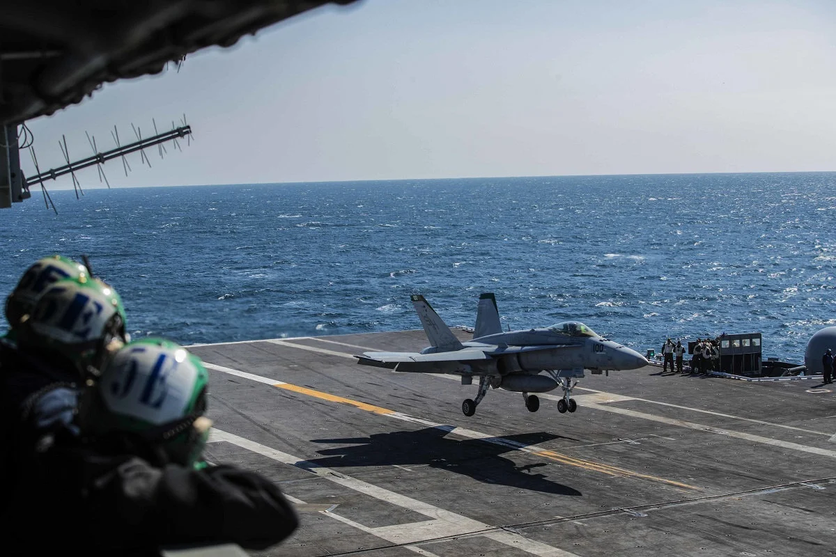 Photo Credit: Sailors observe an F/A-18E Super Hornet land during flight operations aboard the Nimitz-class aircraft carrier USS Abraham Lincoln on March 16, 2018. On Friday, lawmakers approved a massive $1.3 trillion budget deal that includes more money for new aircraft and other military priorities. (Mass Communication Specialist 3rd Class Tyler C. Priestley/Navy)