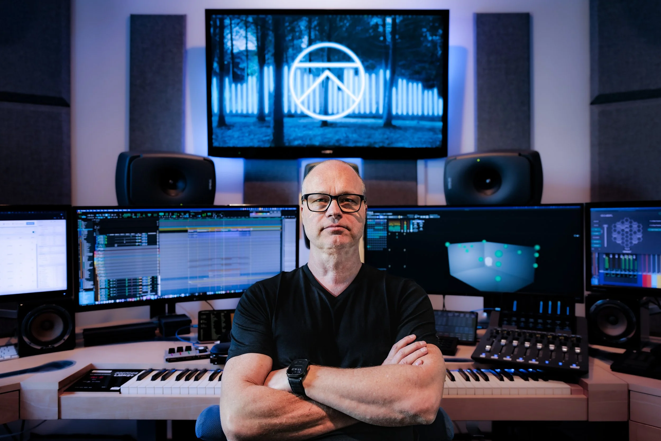 KP in studio with logo.jpg