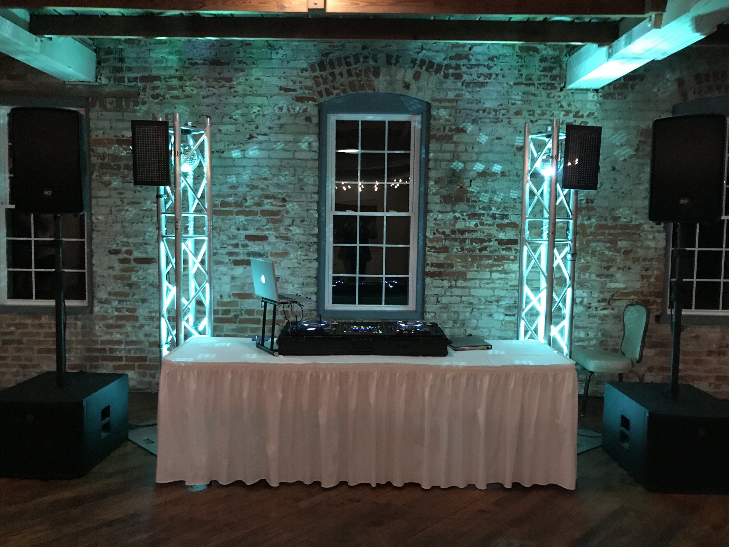 Teal uplights with DJ setup at Bread &amp; Chocolate in Old Bag Factory in Goshen IN