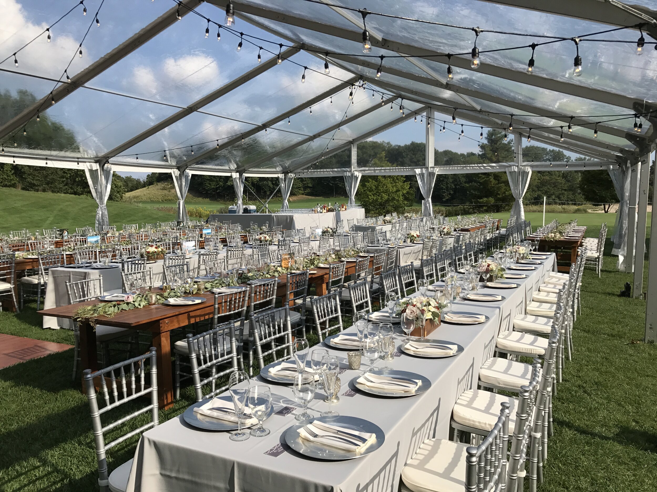 Summer golf course tent wedding table setting in Southwest MI