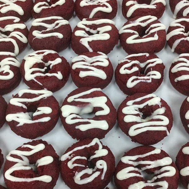 A new favorite, red velvet cake donuts drizzled with our homemade cream cheese icing!