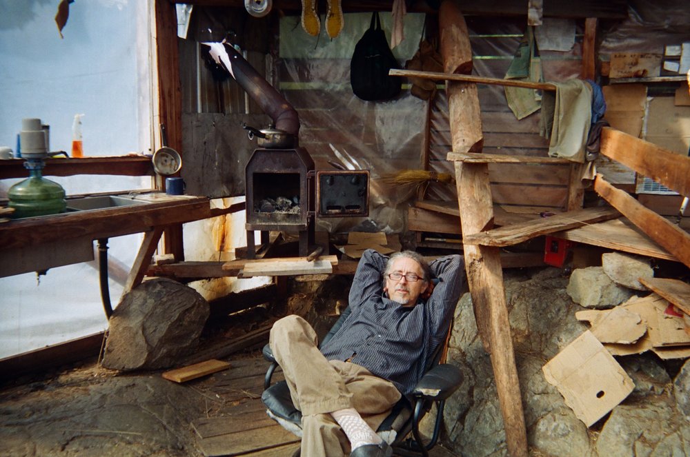 Gerry reclines by the yurt’s hearth, enjoying his pace of life.