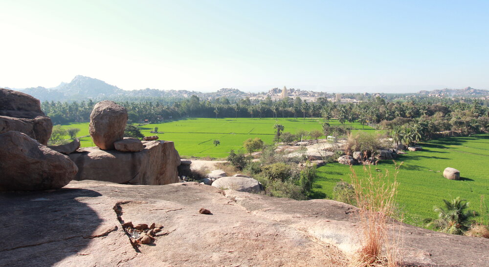 A bouldering sector overlooking the rice fields of Hampi Island and temple spires in the distance. (Photo: Trixie Pacis)