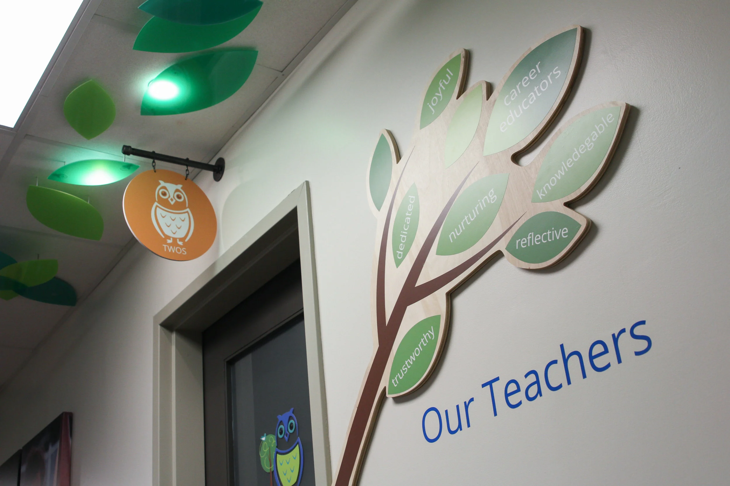 Georgetown Hill Early School // custom acrylic canopy leaves with lighting, signage, and branch tour stops used as talking points on tours with prospective parents.