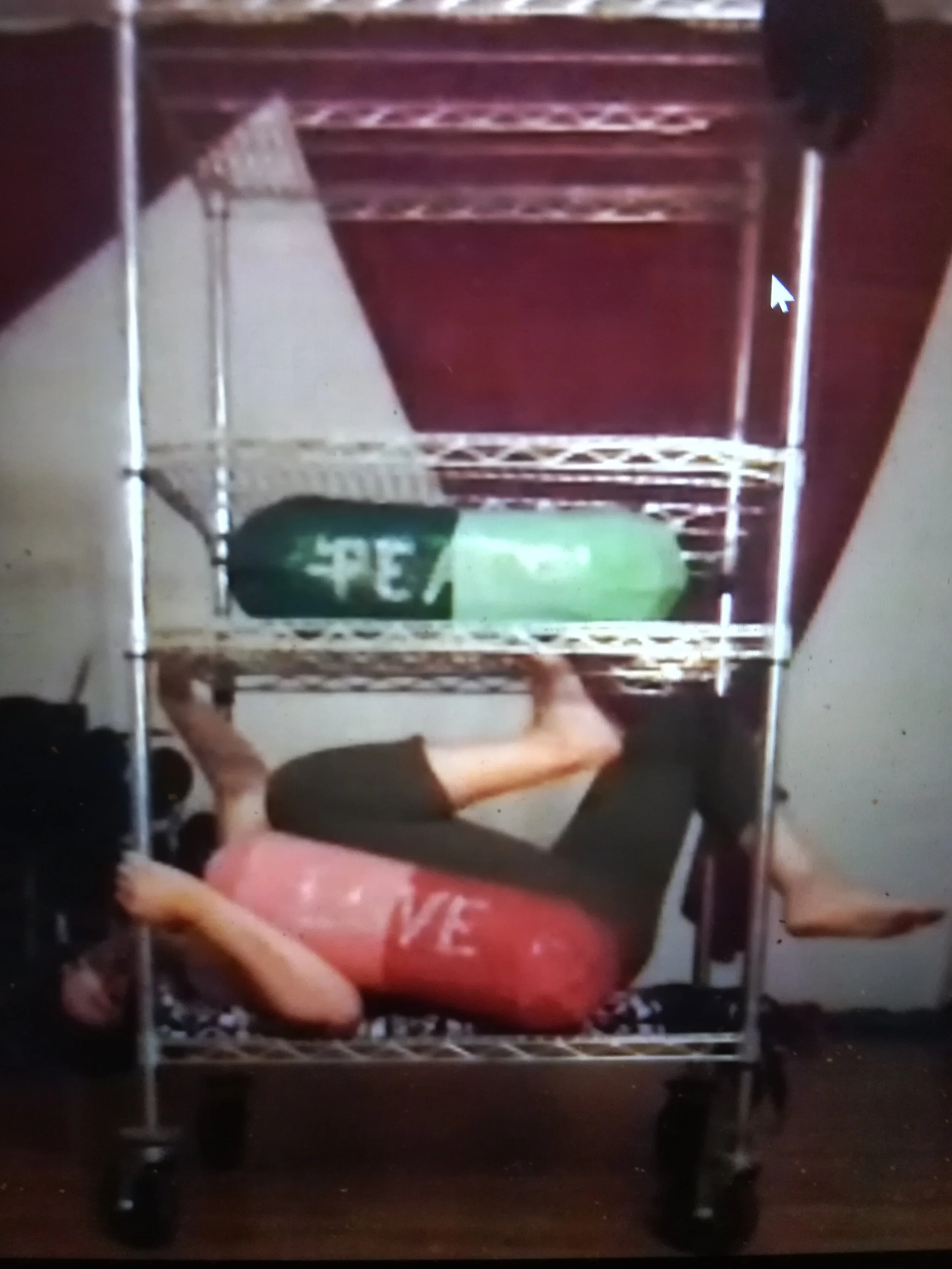  Jackie Rivera plays with a shelf and two giant pills 