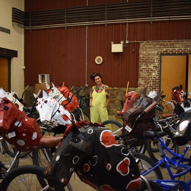 First image -- me, back in 2019 (!), with a fleet of 20+ cardboard-horse-bikes created for @agilerascaltheatre, an innovative theater company that intersects arts + cycling. &lt;3 Agile Rascal projects always expand my imagination and is one of my fa
