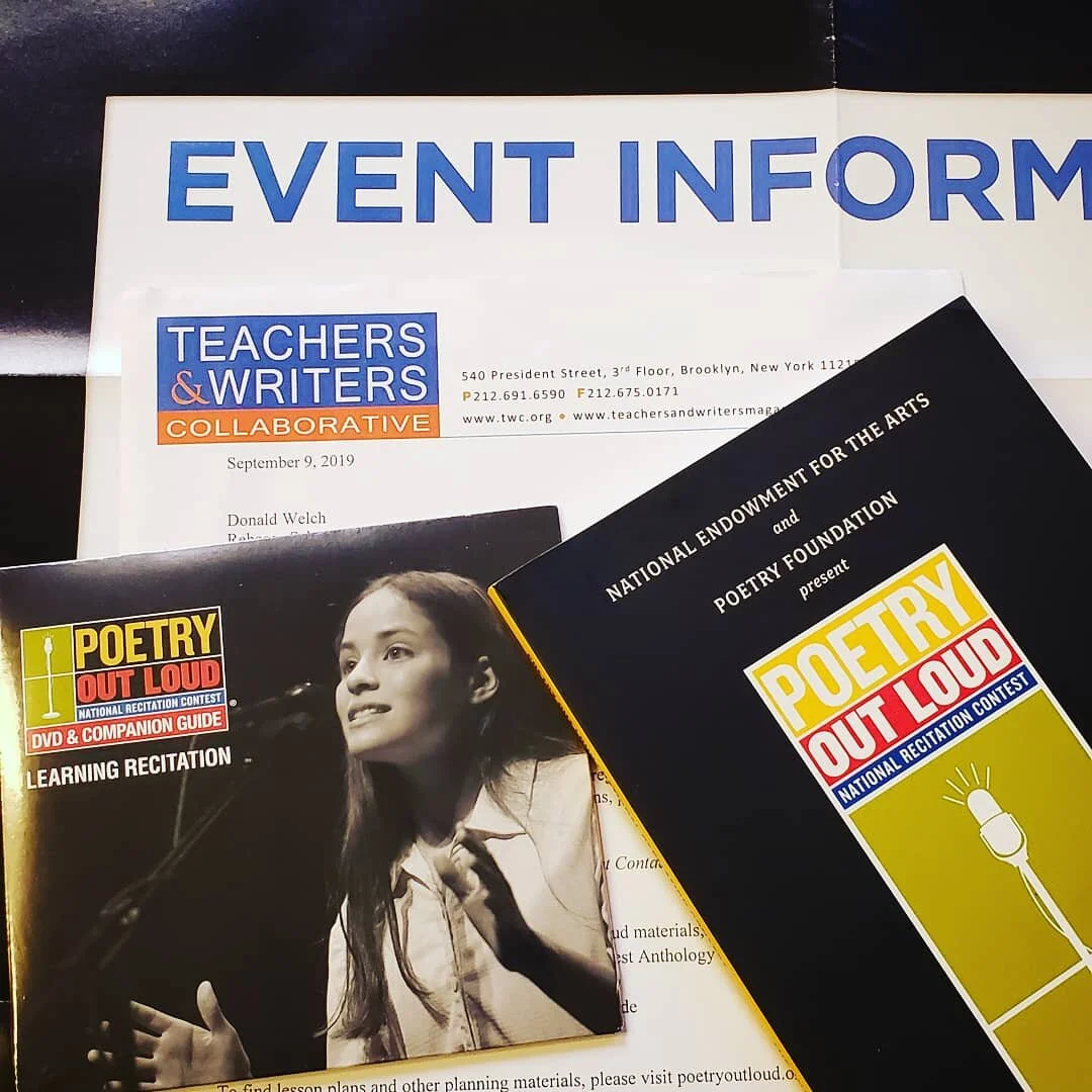 Poetry Out Loud materials laid out on top of one another. All in red, black, yellow, and blue colors. The materials include an anthology of poems, CD entitled “Learning Recitation", a letter, and an event poster.