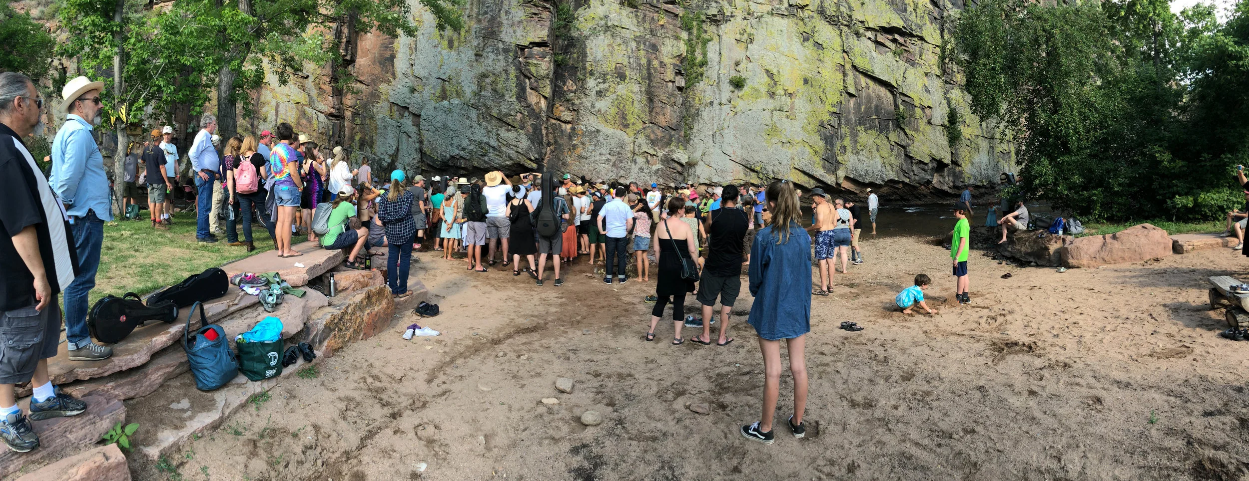 Attendees at the 2017 RockyGrass Academy singing gospel in the St. Vrain river at the culmination of the Academy.