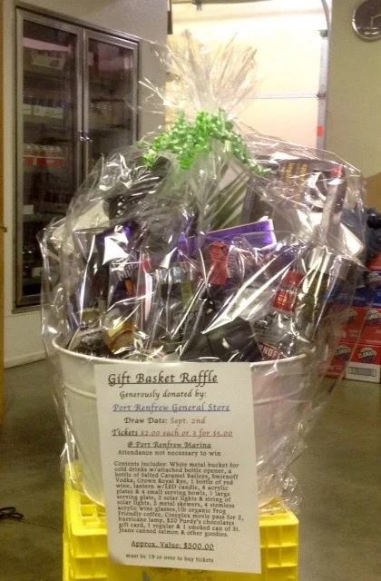 Gift Basket: Draw date: Sept. 2nd Contents: White metal bucket for cold drinks with built in bottle opener, Salted caramel Baileys, Absolut vodka, Crown Royal Rye, bottle of red wine, lantern w/ LED light, 4 acrylic stemless wine glasses, 1 large serving platter, 4 luncheon plates, 2 solar lights and a string of solar lights, 4 small serving bowls, 2 metal skewers, 1 lb Friendly Frog organic coffee, Cineplex movie pass for 2, $20 gift card for Purdy's Chocolates, 1 regular and 1 smoked can of St.Jeans Canned salmon and other goodies. Buying tickets for this basket gives you a chance to win these great items and also help the salmon, a win/ win deal! Check it out at the general store. Value of the basket is approx. $300.00! Bud & Rex
