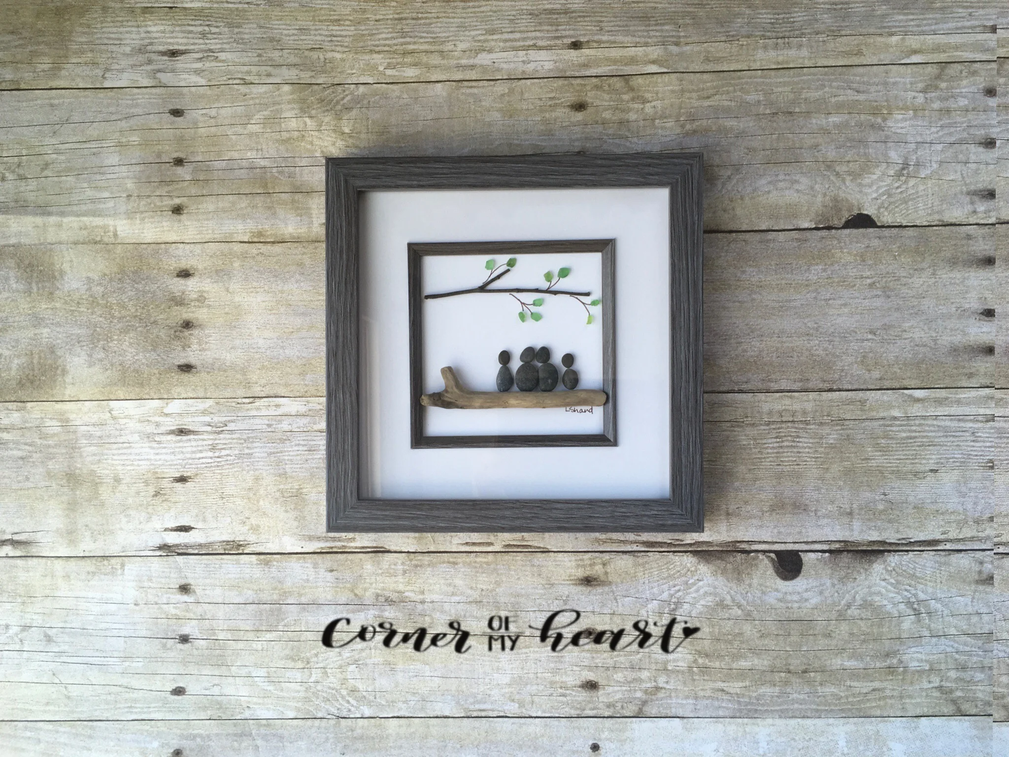 Family of four seated on driftwood