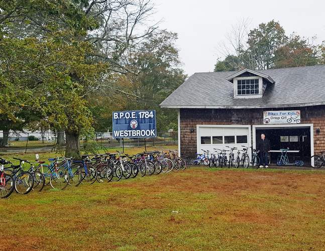 Rick Sheldon, past exalted ruler of the Westbrook Elks Lodge, looks over some of the bikes collected for the Bikes for Kids program. (Photo by Richard Siedzik )