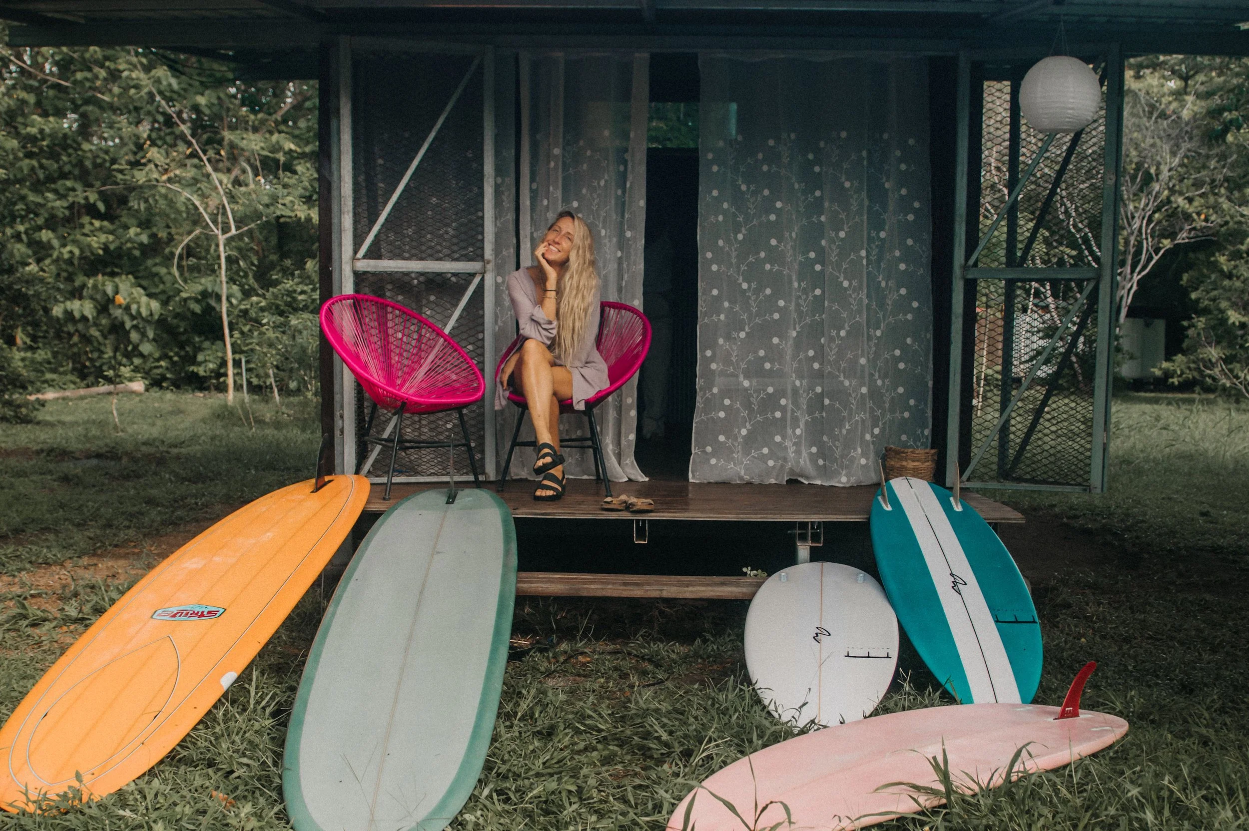 Evie and surfboards during a product photography shoot in Costa Rica