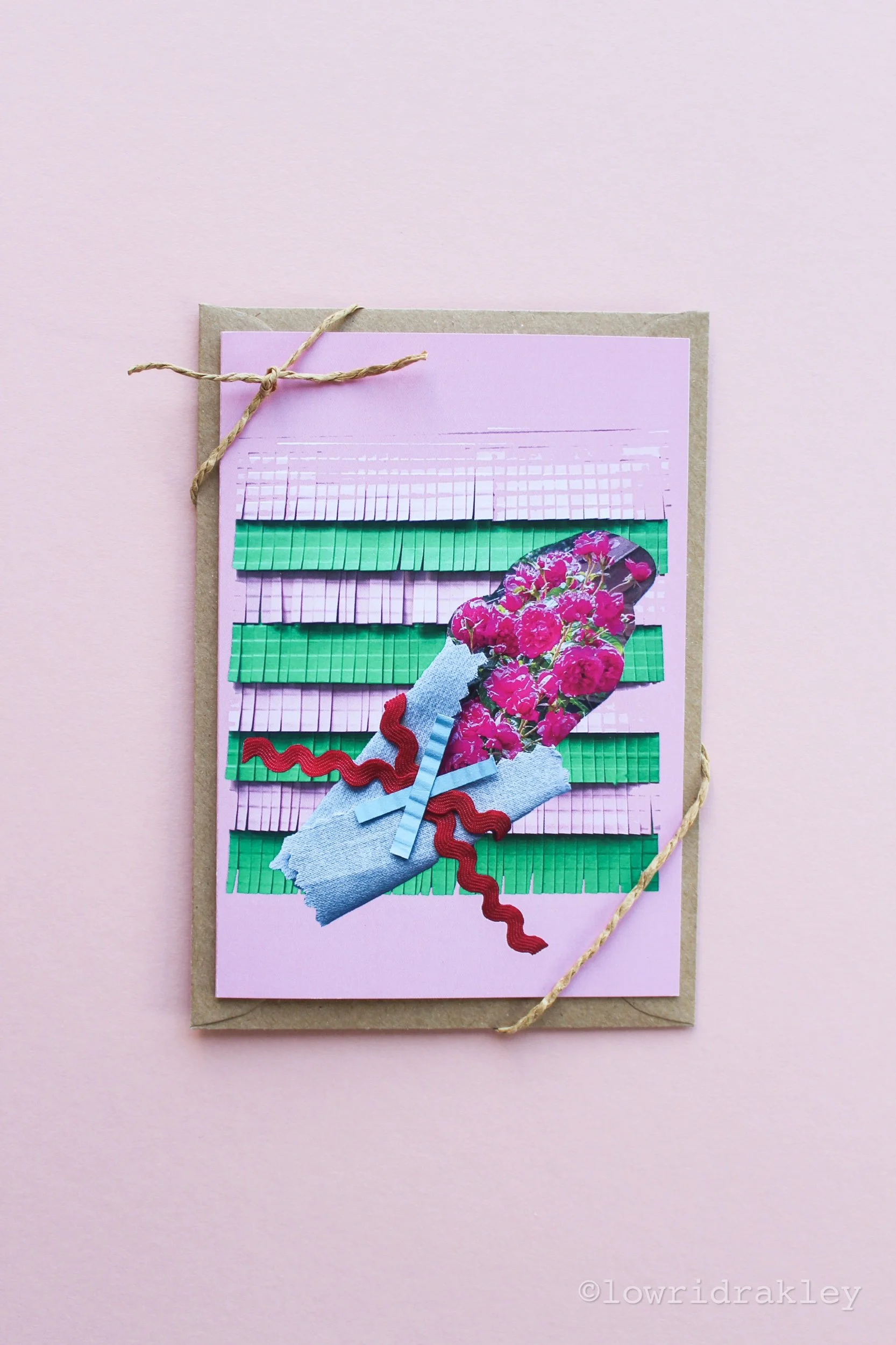 Handmade mixed-media greeting card featuring a vibrant pink rose bouquet collage on a fringed green and lilac background.