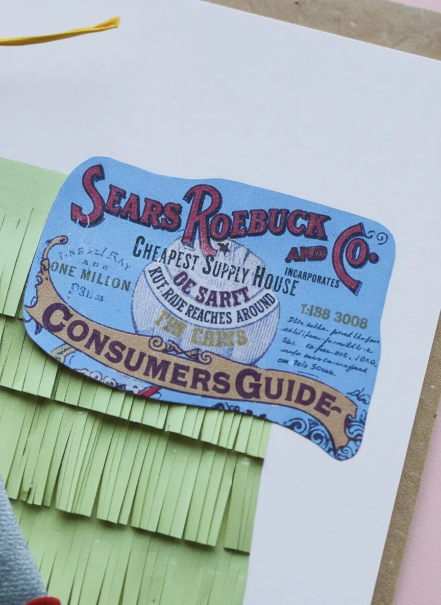 A close-up of a blue vintage Sears Roebck and Co. "Consumers Guide" label fragment, featuring red and black typography, layered over yellow fringed paper in a handmade collage.