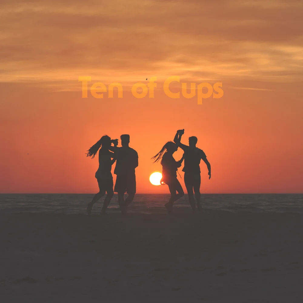 Silhouetted figures dance and embrace on the beach at sunset. The sun hovers low over the ocean horizon, casting golden and orange light through a serene sky.