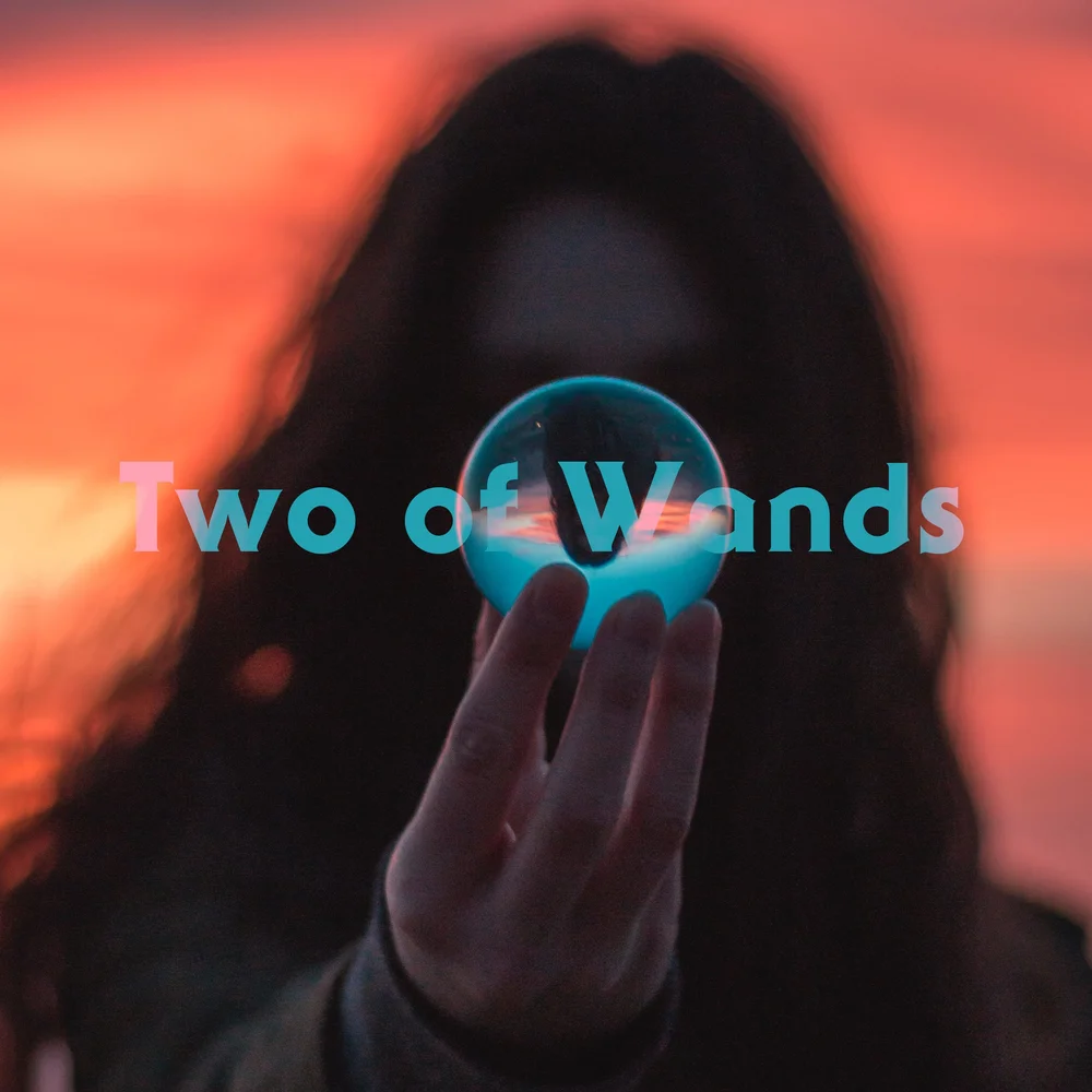 A shadowed figure holds a glowing blue orb toward the camera, silhouetted by a burning sunset. The horizon reflects in the sphere — a vision held close, a future seen, but waiting to be chosen.