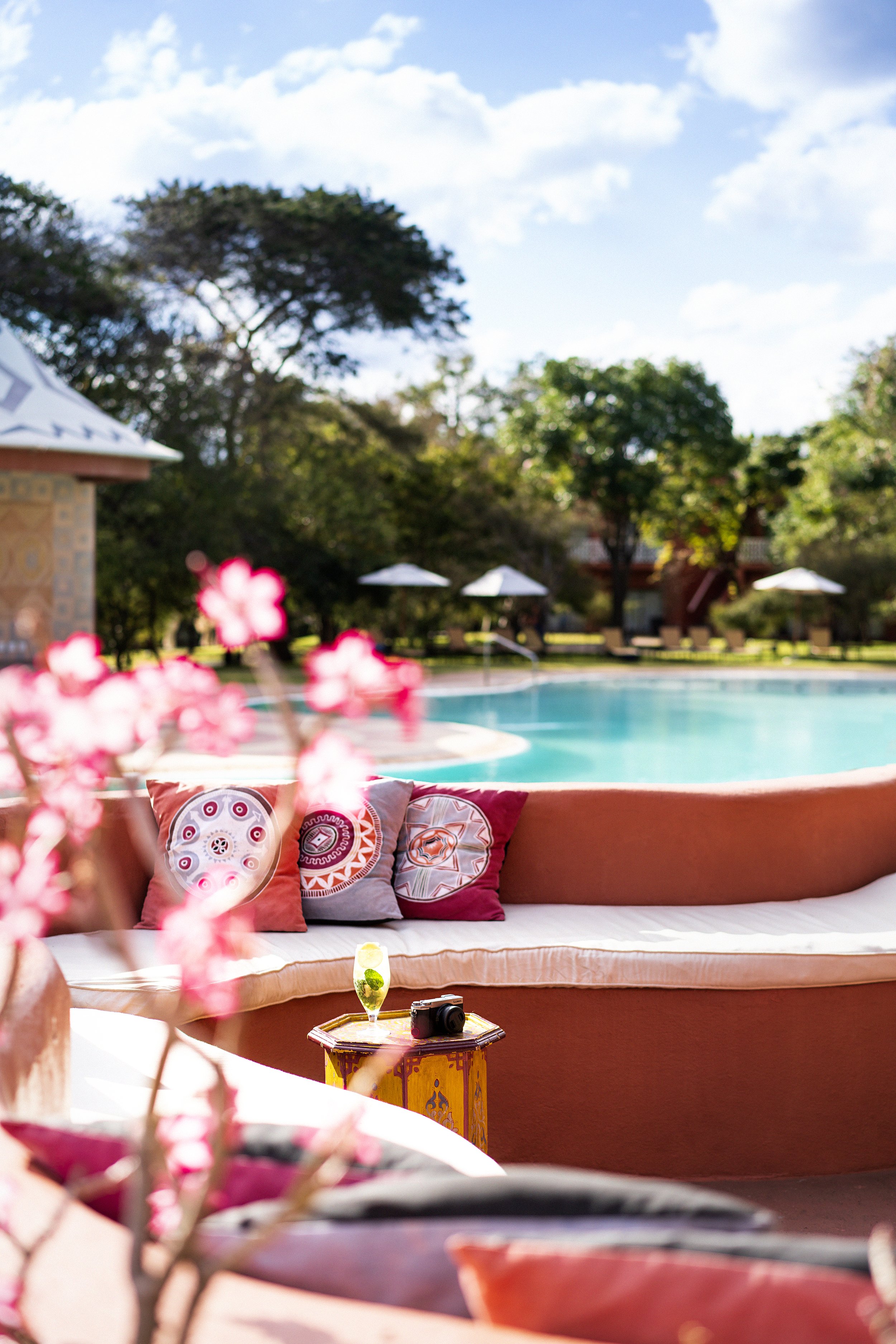 Avani_Victoria_Falls_Resort_Pool_View_Pool_Seating_With_Flowers.jpg
