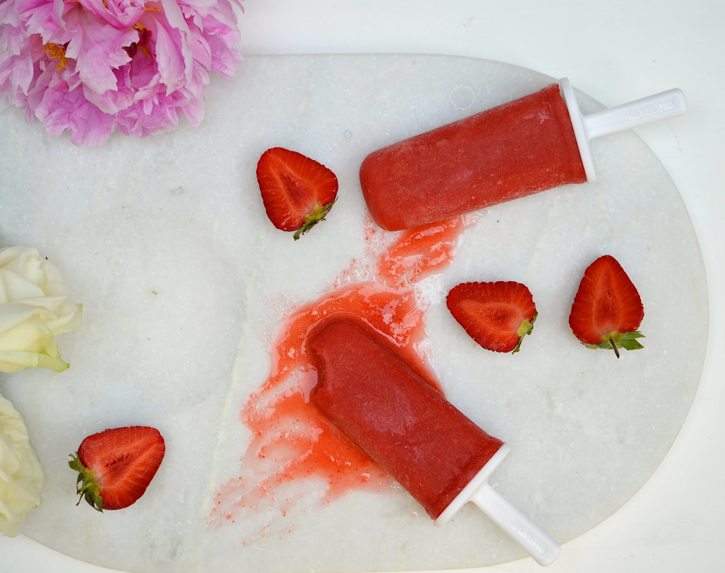 Strawberries are in season everywhere so it is the perfect time to be making ice lollies. These are definitely one of your five a day and are so easy as there are only 4 ingredients and one is water. Phoenix and Ines (nephew and niece) can't get enough of them!! This is gluten/dairy/free Makes about 6 lollies Ingredients: 600g fresh strawberries, stem removed 200ml cold water Juice and zest of 1/2 a lemon 110ml honey Add all the ingredients to a blender and blitz until combined and smooth. Taste to check the flavour. It should taste a little too sweet as when it freezes it looses some of the sugar taste. Pour into ice lolly moulds and leave in the freezer for about 3-4 hours or overnight. To release, place mould under warm water for about 20 seconds and it should release from the mould. If it doesn't come away easily put under water for a few more seconds. Bon!