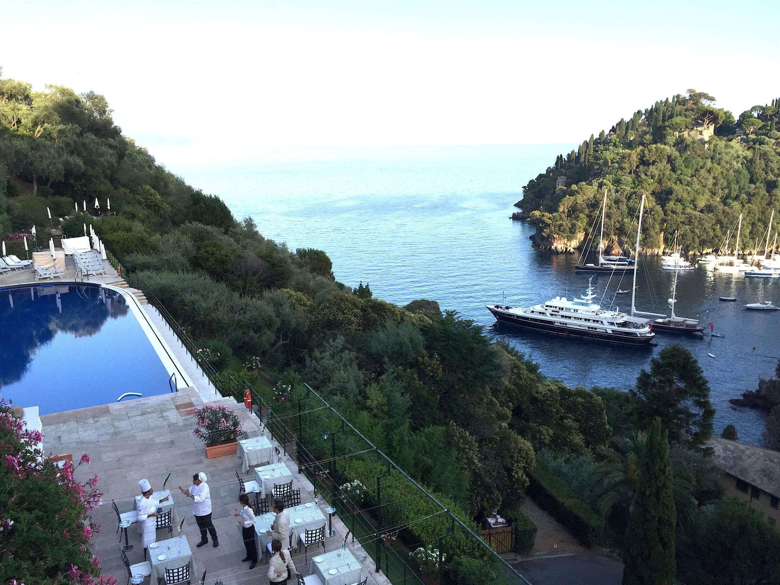 Hotel Splendido Famous for being part of one of the most prestigious and elegant hotel groups in Italy. This place for dinner is definitely a treat but I had a wonderful and unforgettable time for 100 euros. You are paying for the stunning view which I'm sure I recognised from a few Slim Aarons shots. All the sights from the road off the coast are good but the Splendido has the ultimate vista point. You walk through an amazing garden filled with flowers and when you reach the top you are greeted with a breathtaking view of their pool followed by the harbour. I ate a local dish from Liguria of ravioli filled with vegetables, parmesan and a creamy walnut sauce. This is what you should get or even the Elizabeth Taylor three tomato spaghetti! Worth visiting if only for pre or post dinner drinks. Via Roma, 2, 16034 Portofino GE, Italy +39 0185 267800 http://www.belmond.com/hotel-splendido-portofino/