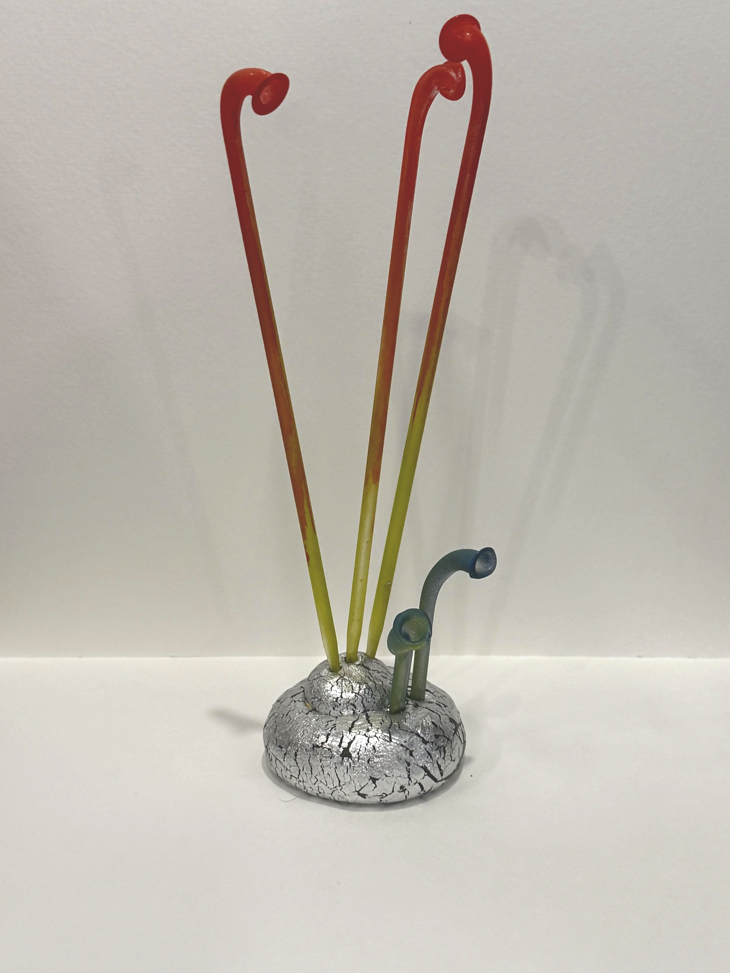 abstract plant sculpture, colorful whimsical art, alien plant sculpture, reclaimed materials, surreal art