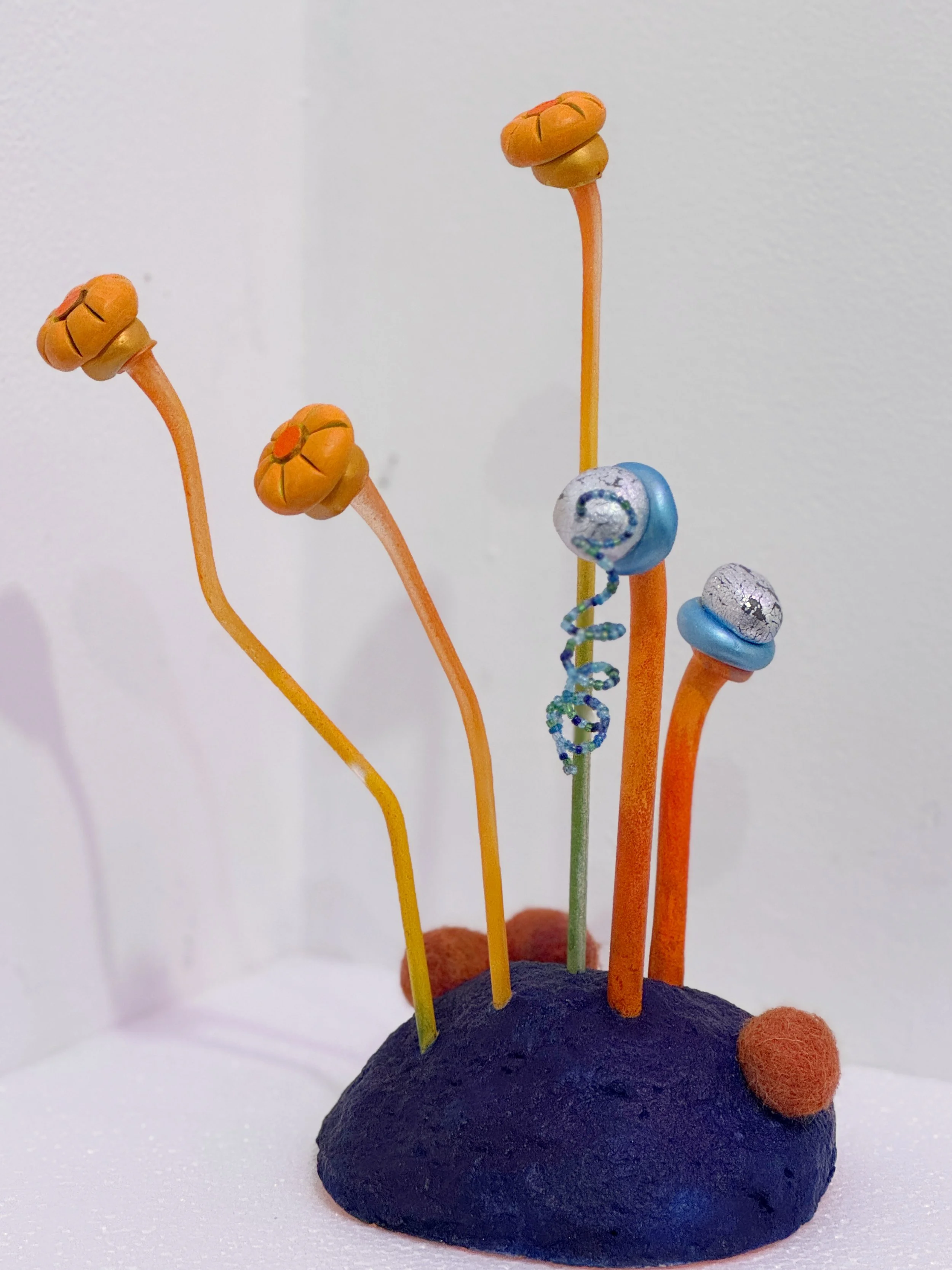 small sculpture, abstract plant art, lichen sculpture, flower sculpture, cobalt blue and orange sculpture, reclaimed materials, whimsical art