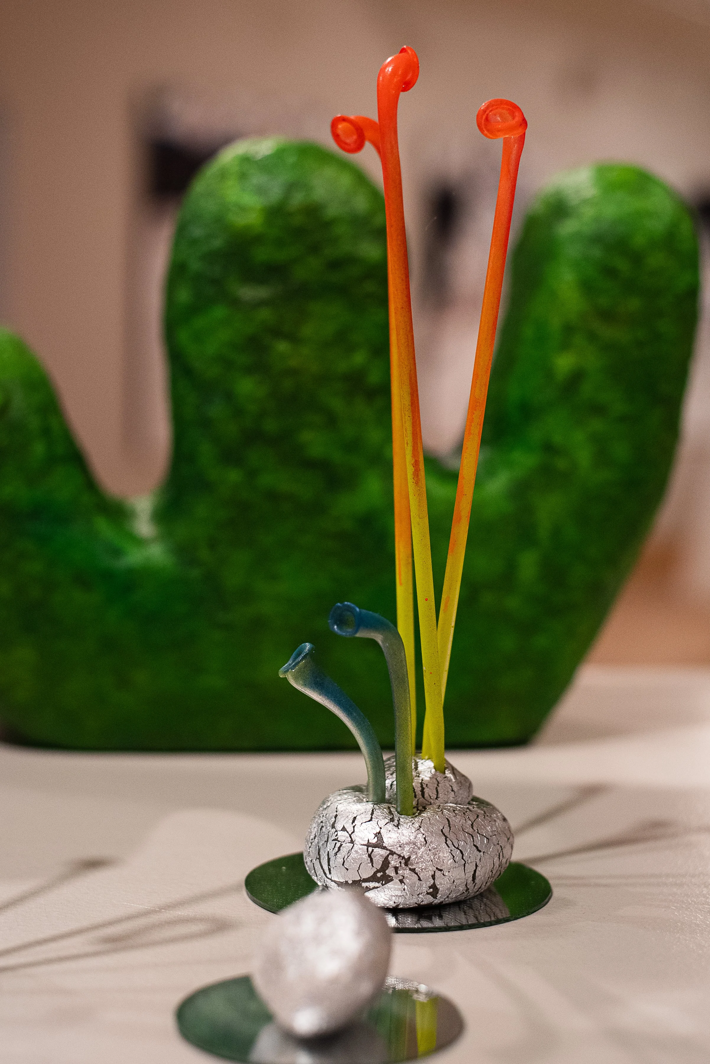 abstract plant sculpture, colorful whimsical art, alien plant sculpture, reclaimed materials, surreal art