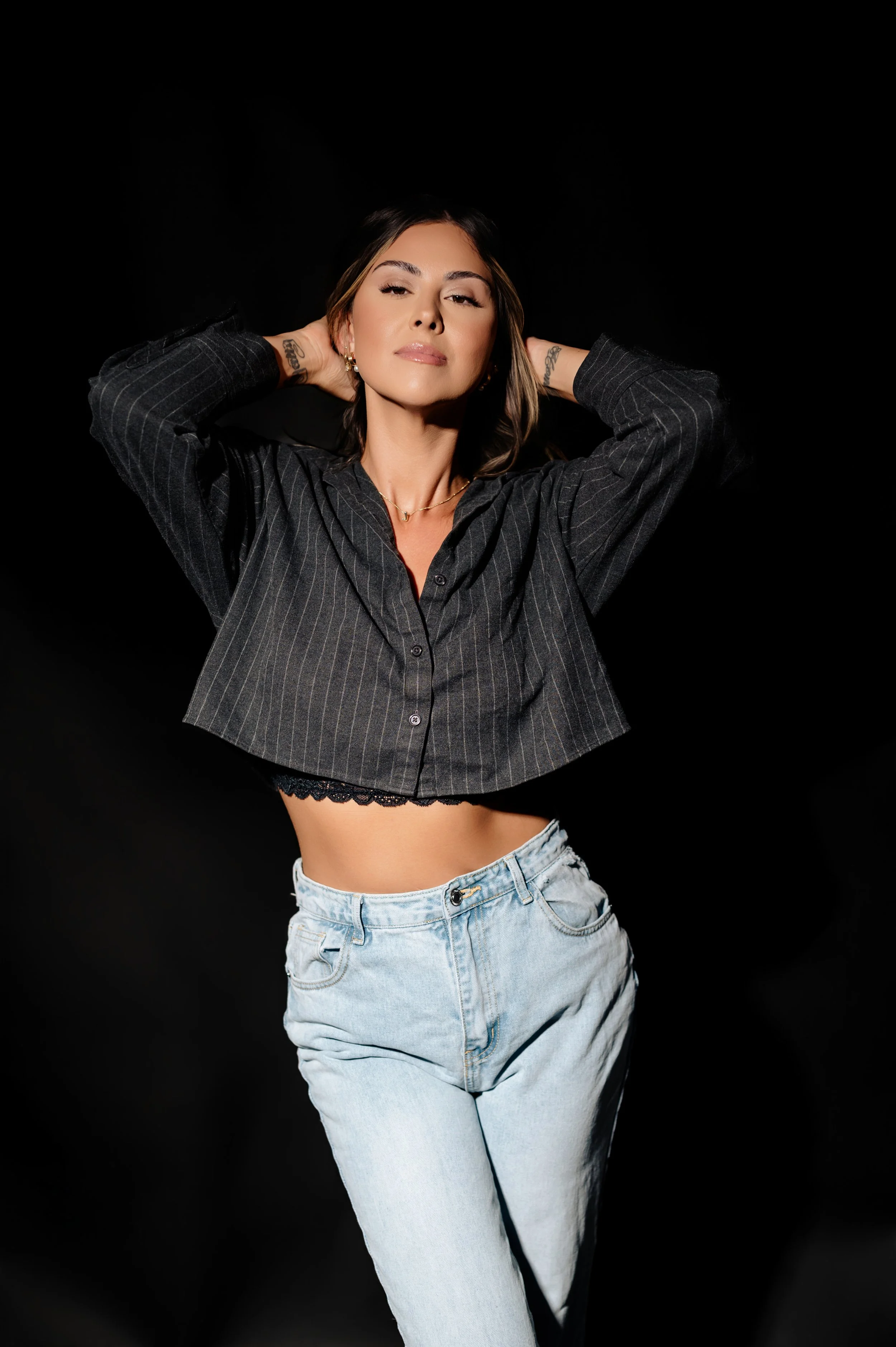Sophisticated studio portrait of a woman in natural light photographed by Elizabeth Young Photography.
